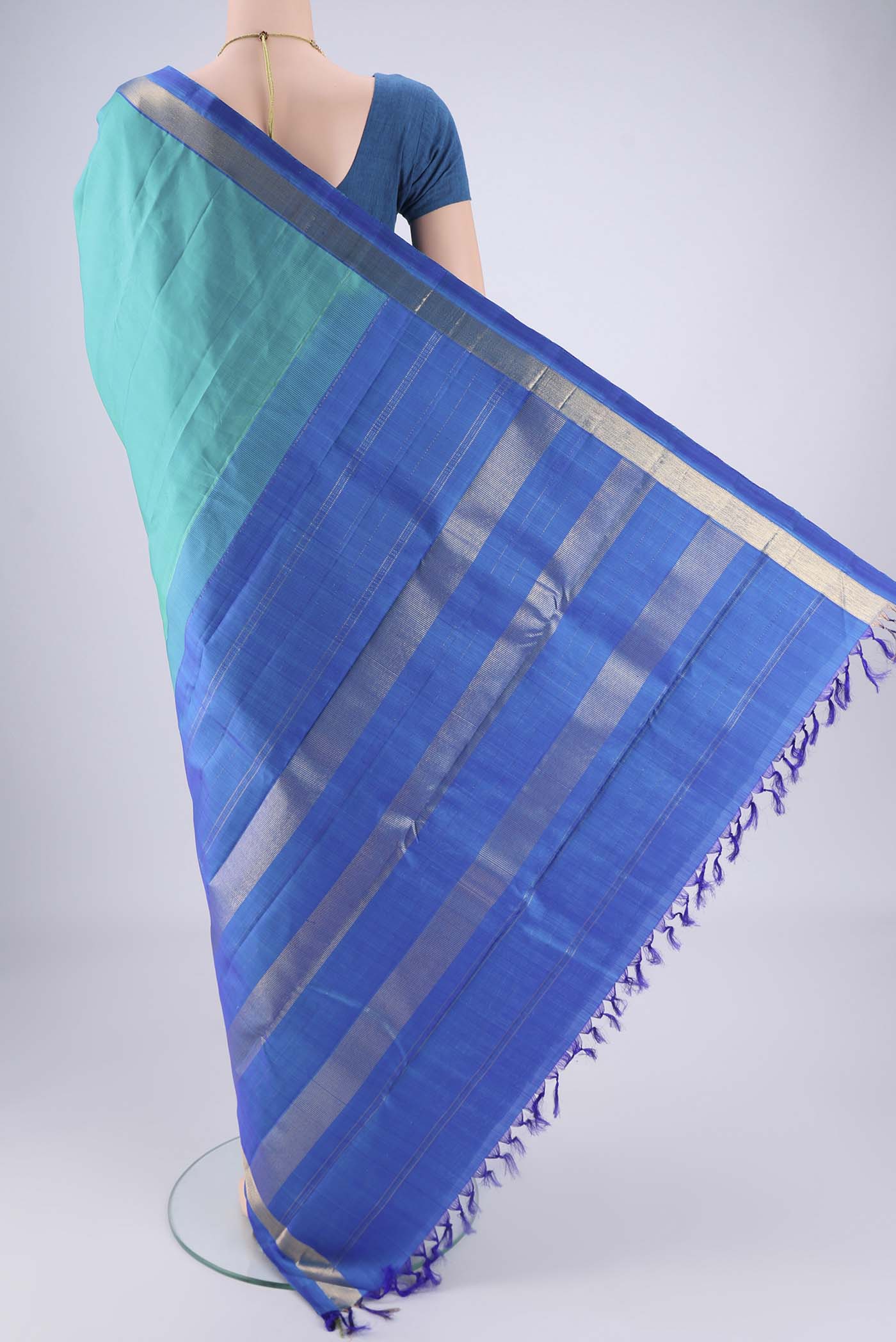 Flat view of Turquoise Kanjivaram Saree with Plain Body and Zari Border. 