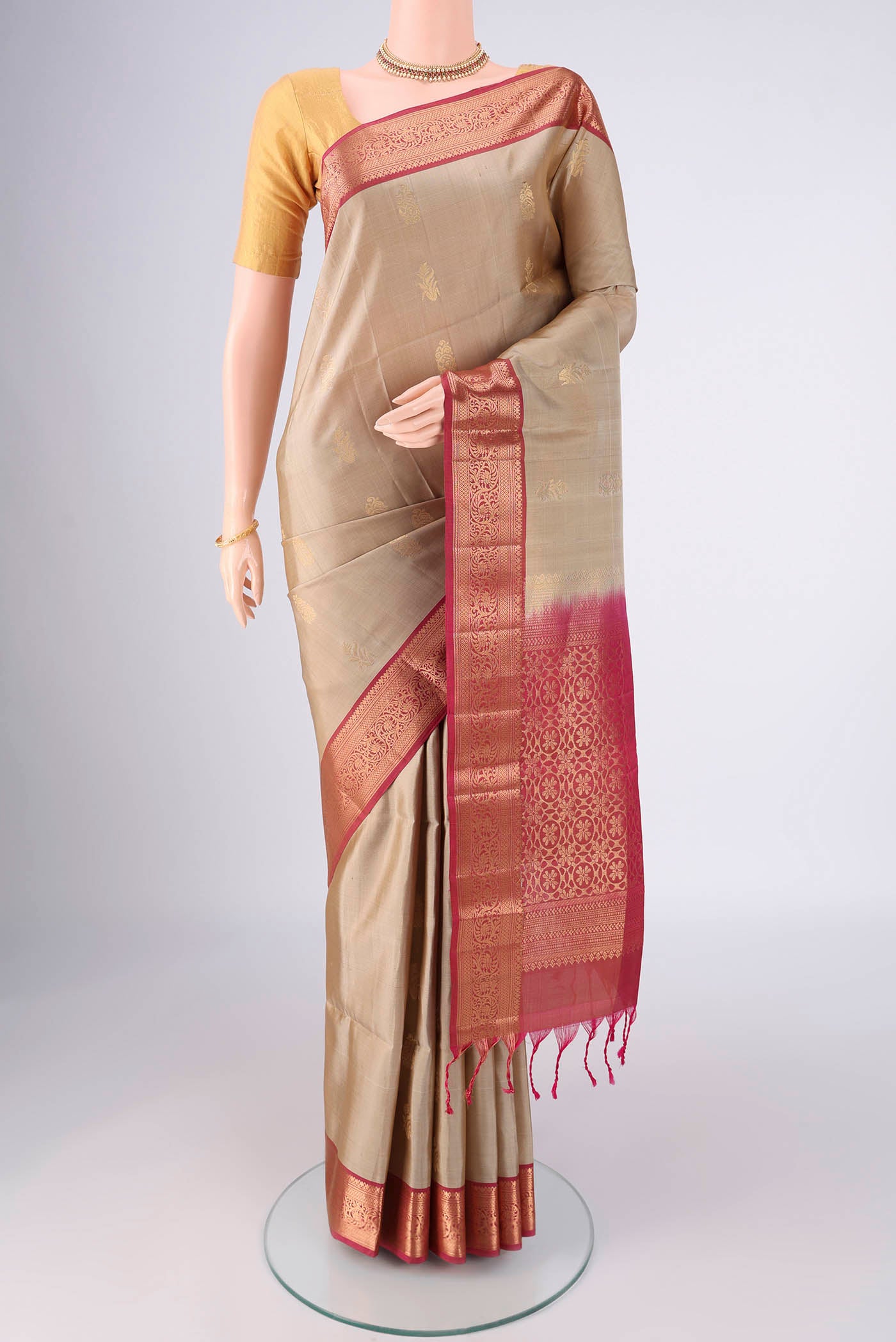 Beige Soft Silk Saree with Zari Butta on the body and Zari Border.  displayed on a mannequin