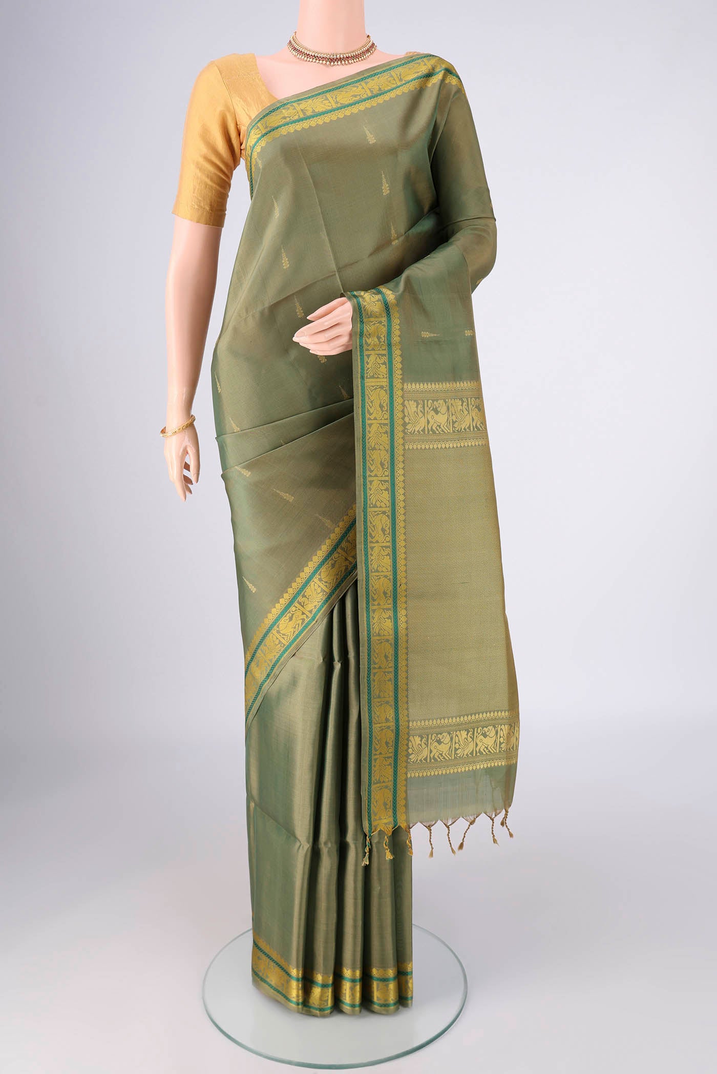 Sage Green Soft Silk Saree with Stripes on the body and Zari And Thread Border.  displayed on a mannequin