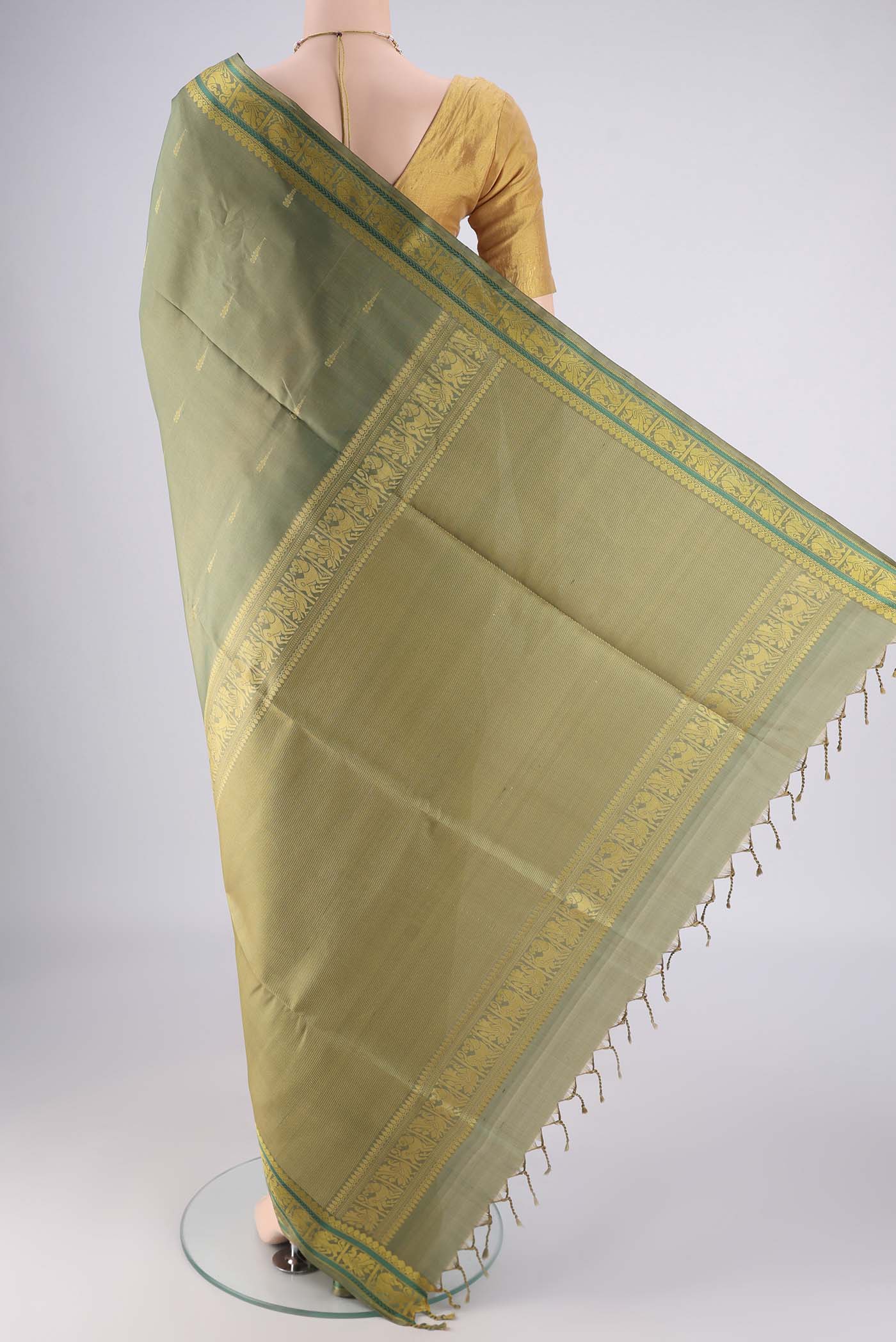 Flat view of Sage Green Soft Silk Saree with Stripes on the body and Zari And Thread Border. 