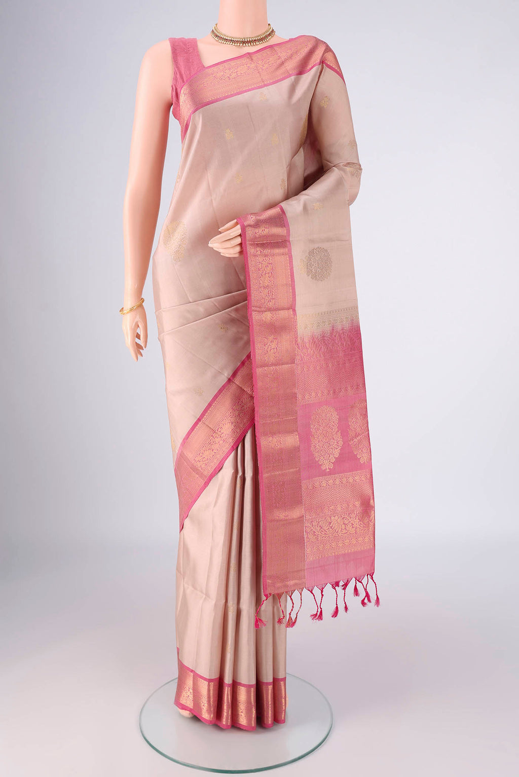 Beige Soft Silk Saree with Zari Butta on the body and Zari Border.  displayed on a mannequin