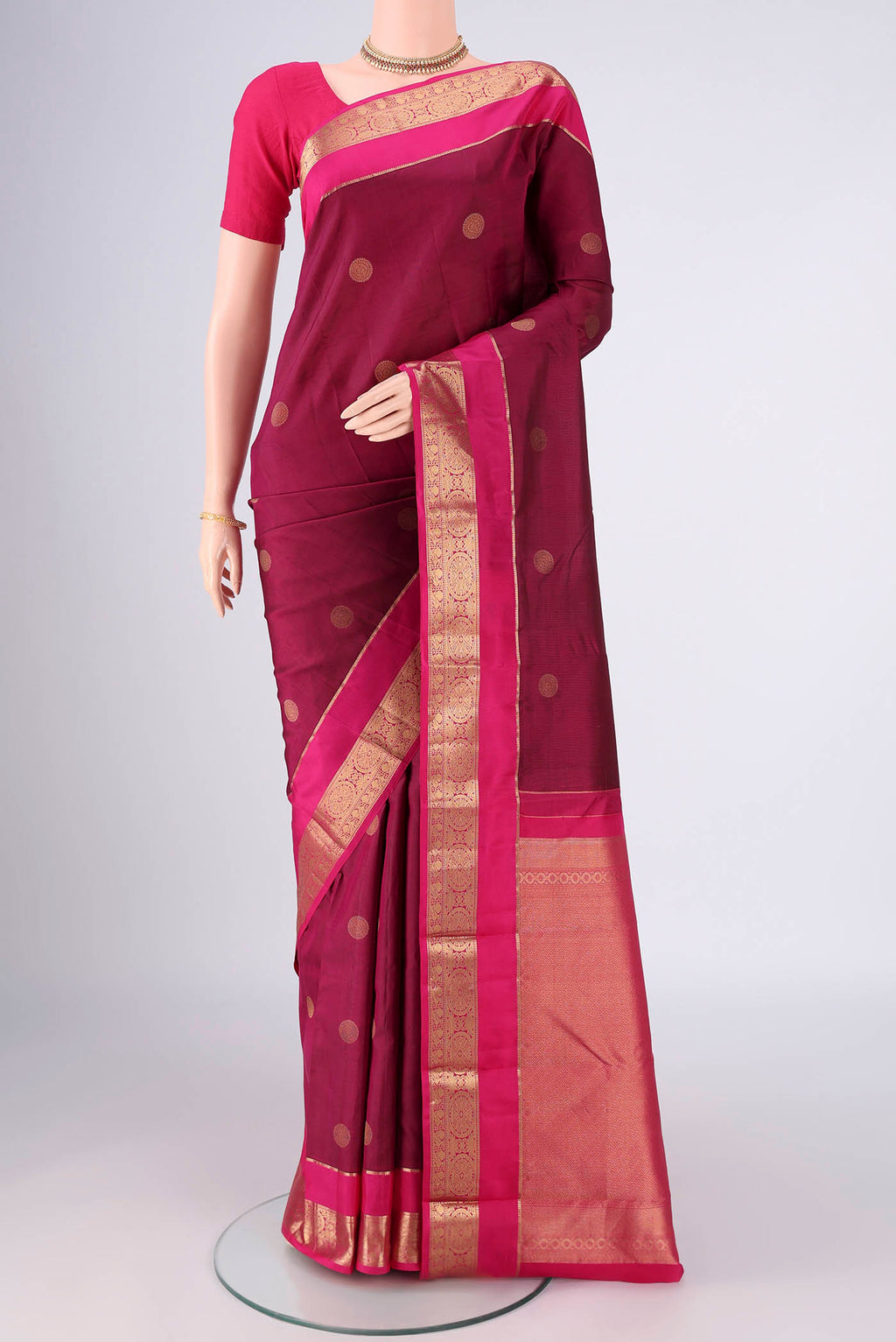 Light Magenta Kanchipuram Silk Saree with Zari Butta on the body and Zari Border.  displayed on a mannequin