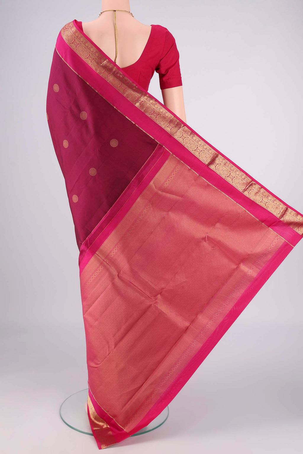 Flat view of Light Magenta Kanchipuram Silk Saree with Zari Butta on the body and Zari Border. 