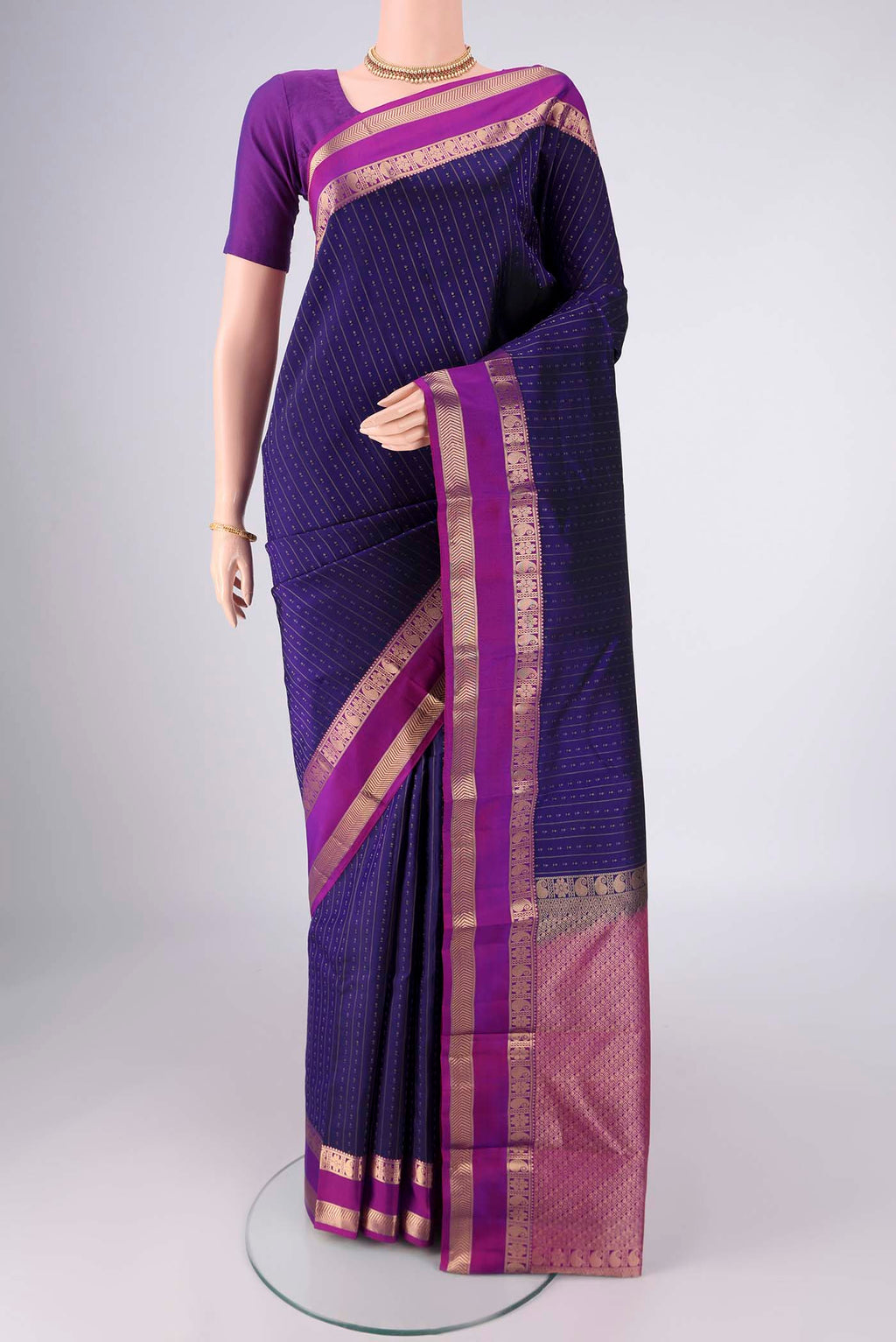 Dark Blue Kanchipuram Silk Saree with Zari Butta on the body and Zari Border.  displayed on a mannequin