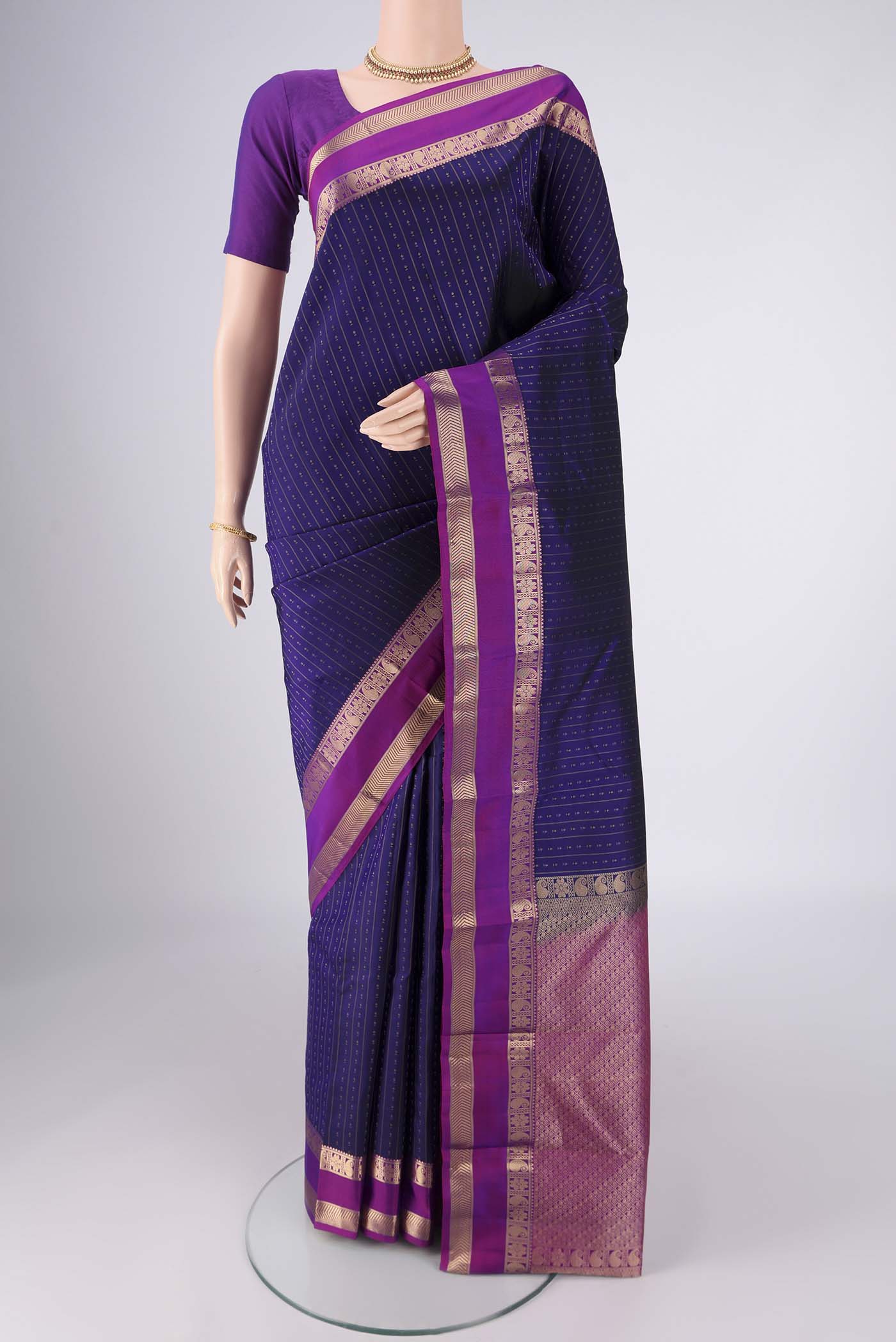 Dark Blue Kanchipuram Silk Saree with Zari Butta on the body and Zari Border.  displayed on a mannequin