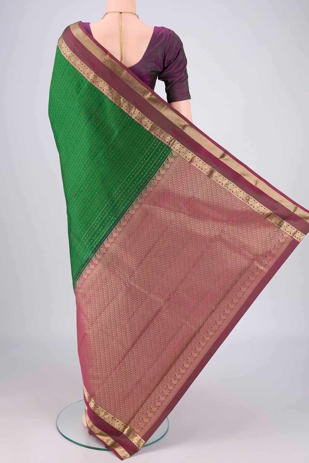 Flat view of Green Kanchipuram Silk Saree with Zari Butta on the body and Zari Border. 