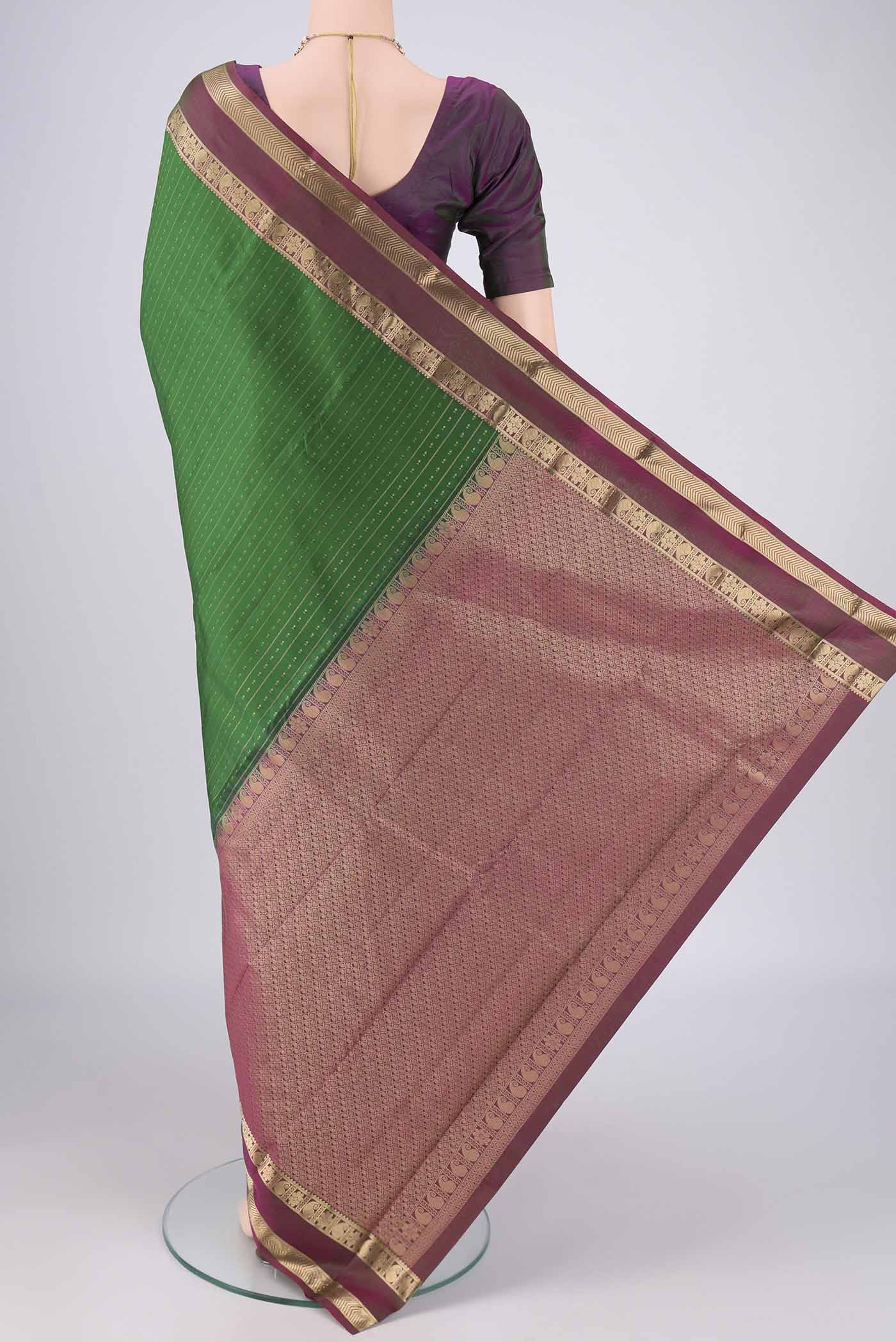 Flat view of Green Kanchipuram Silk Saree with Zari Butta on the body and Zari Border. 
