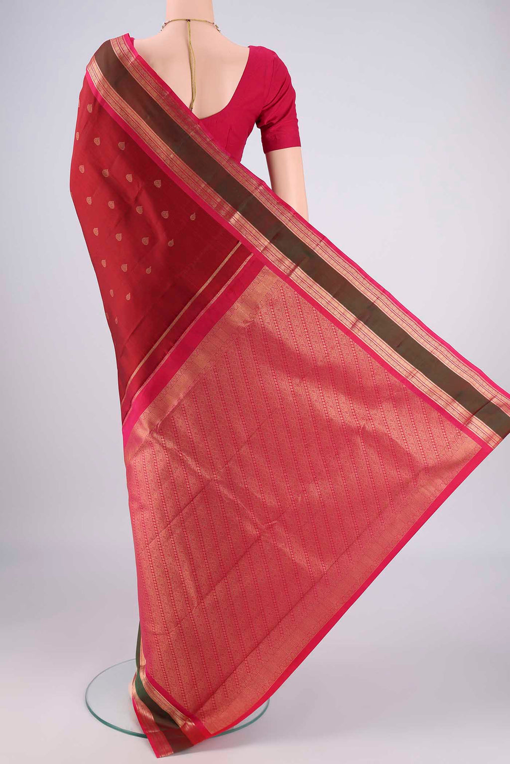 Flat view of Maroon Kanchipuram Silk Saree with Zari Butta on the body and Zari Border. 