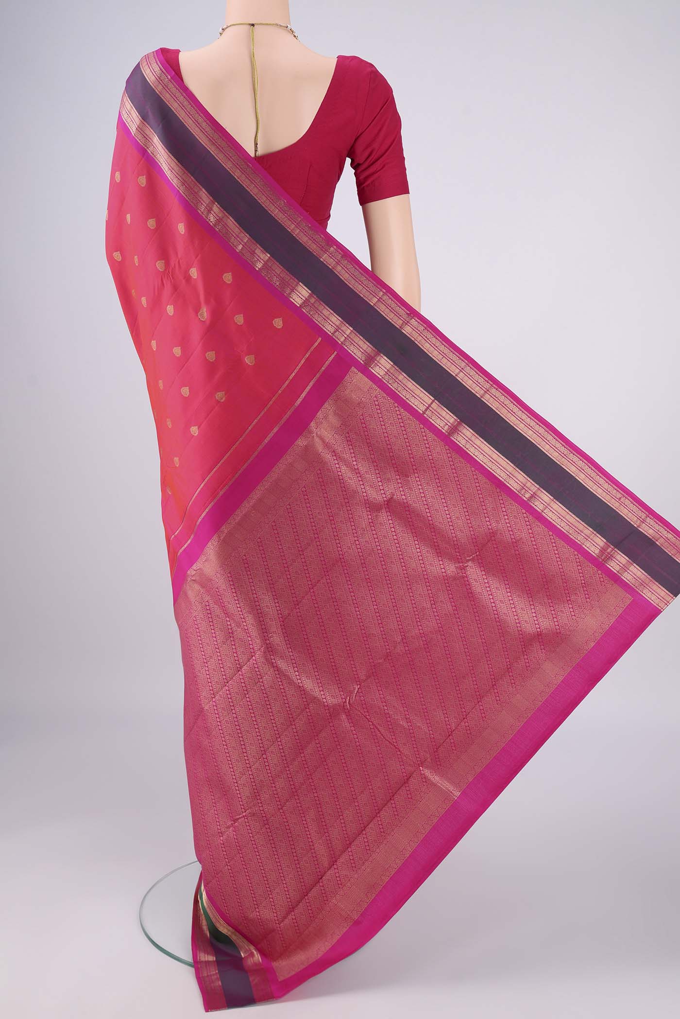 Flat view of Coral Dual Tone Kanchipuram Silk Saree with Zari Butta on the body and Zari Border. 