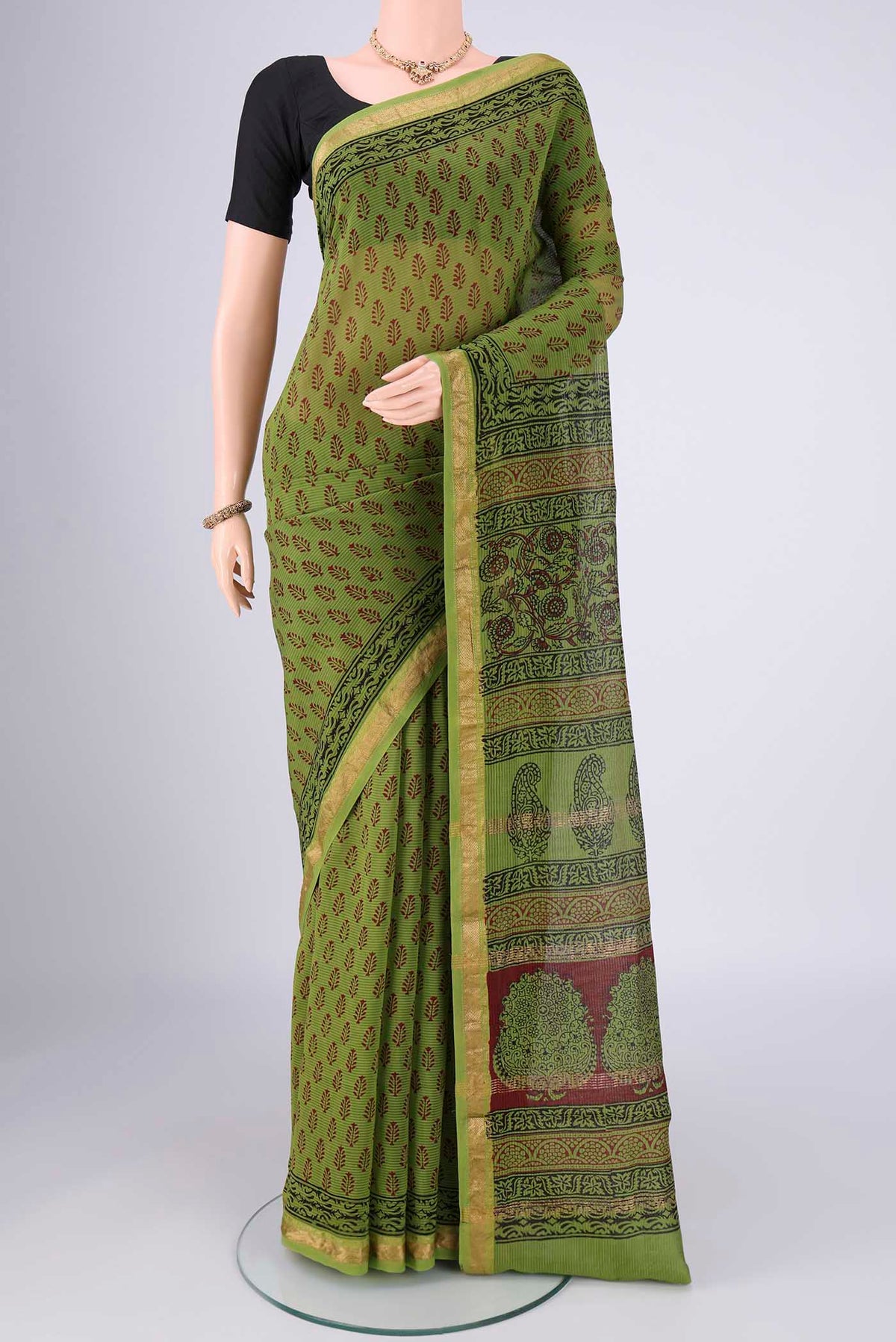 Mehandi Green Maheshwari Silk Cotton Saree with Printed design on the body and Zari Border.  displayed on a mannequin