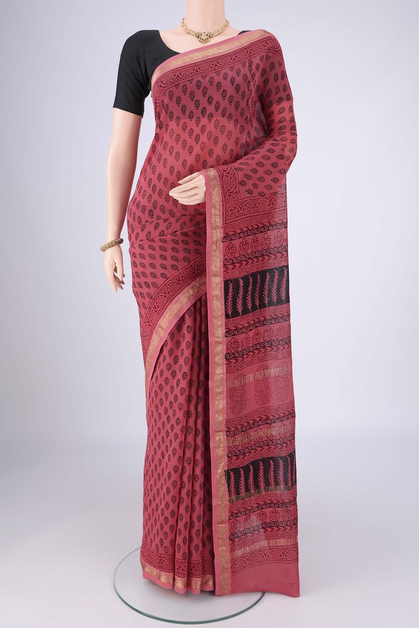 Coral Maheshwari Silk Cotton Saree with Printed design on the body and Zari Border.  displayed on a mannequin