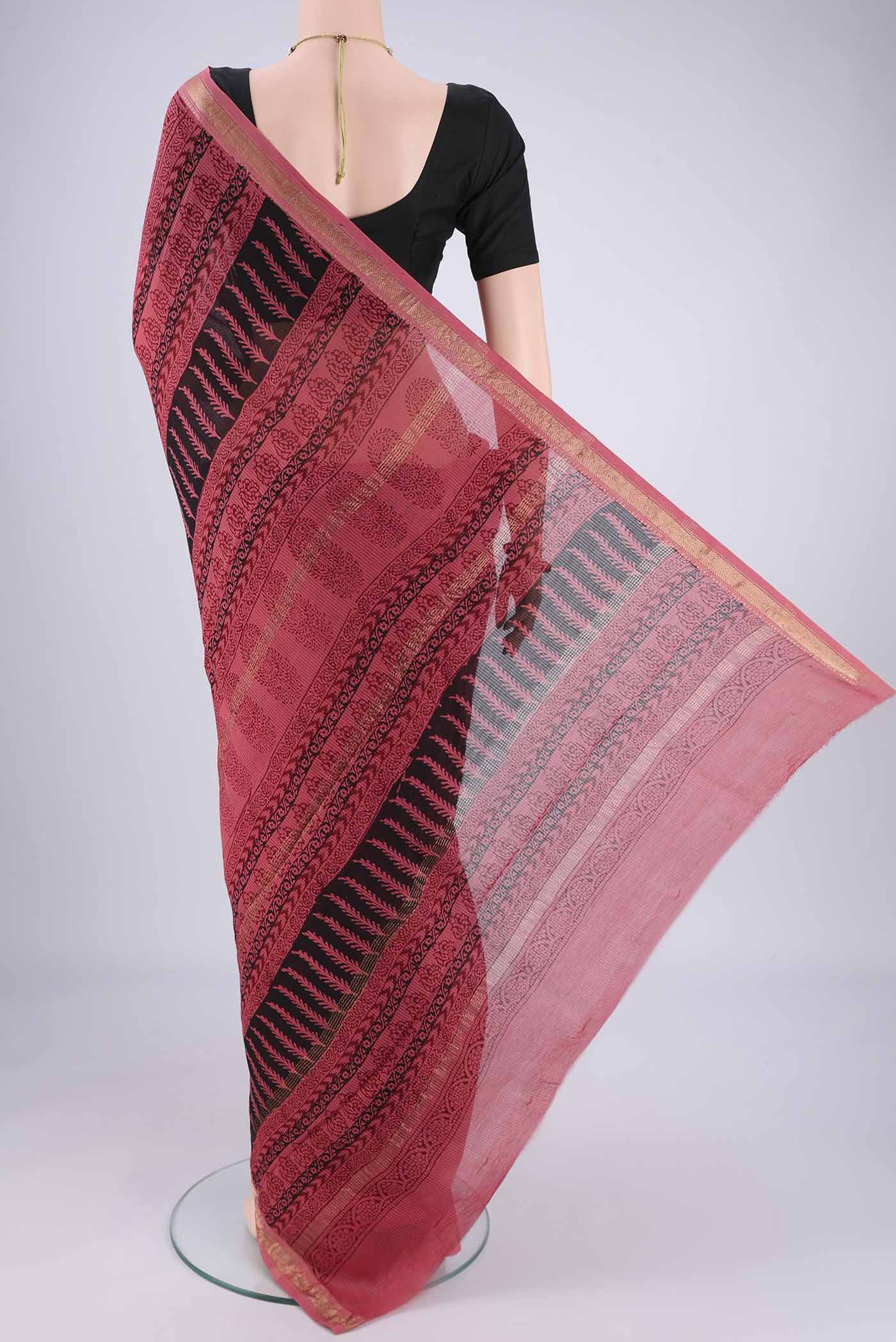 Flat view of Coral Maheshwari Silk Cotton Saree with Printed design on the body and Zari Border. 