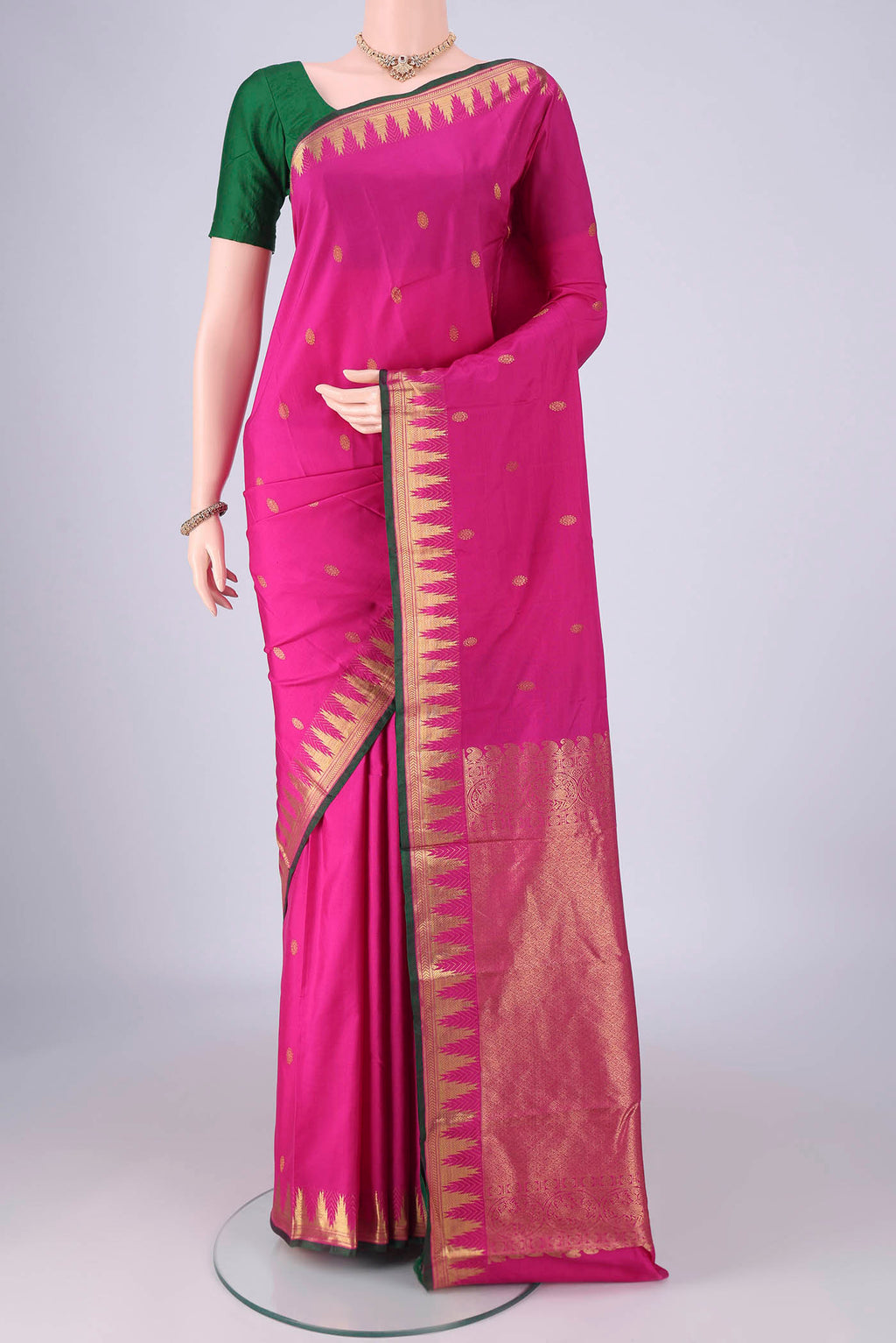 Rani Pink Kanjivaram Silk Saree with Zari Butta on the body and Zari Border.  displayed on a mannequin