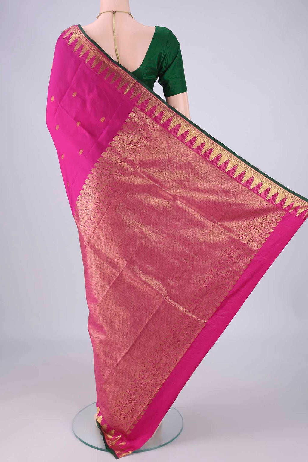 Flat view of Rani Pink Kanjivaram Silk Saree with Zari Butta on the body and Zari Border. 