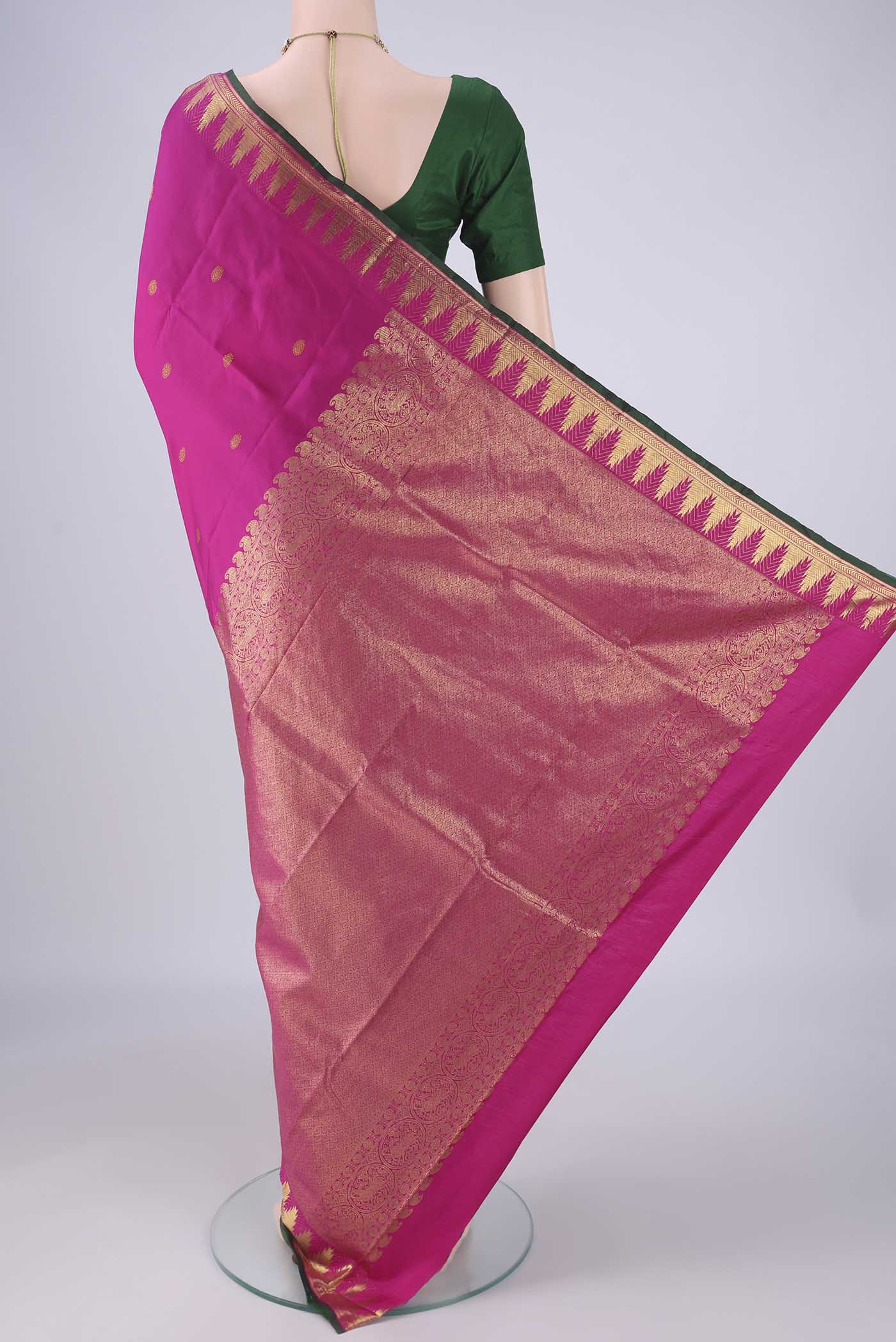 Flat view of Rani Pink Kanjivaram Silk Saree with Zari Butta on the body and Zari Border. 