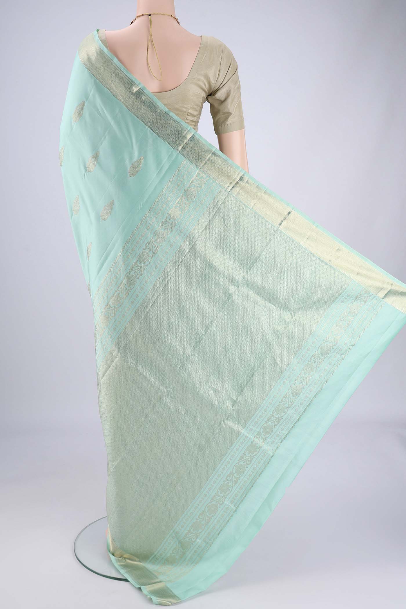 Flat view of Mint Green Dual Tone Kanjivaram Saree with Zari Butta on the body and Zari Border. 