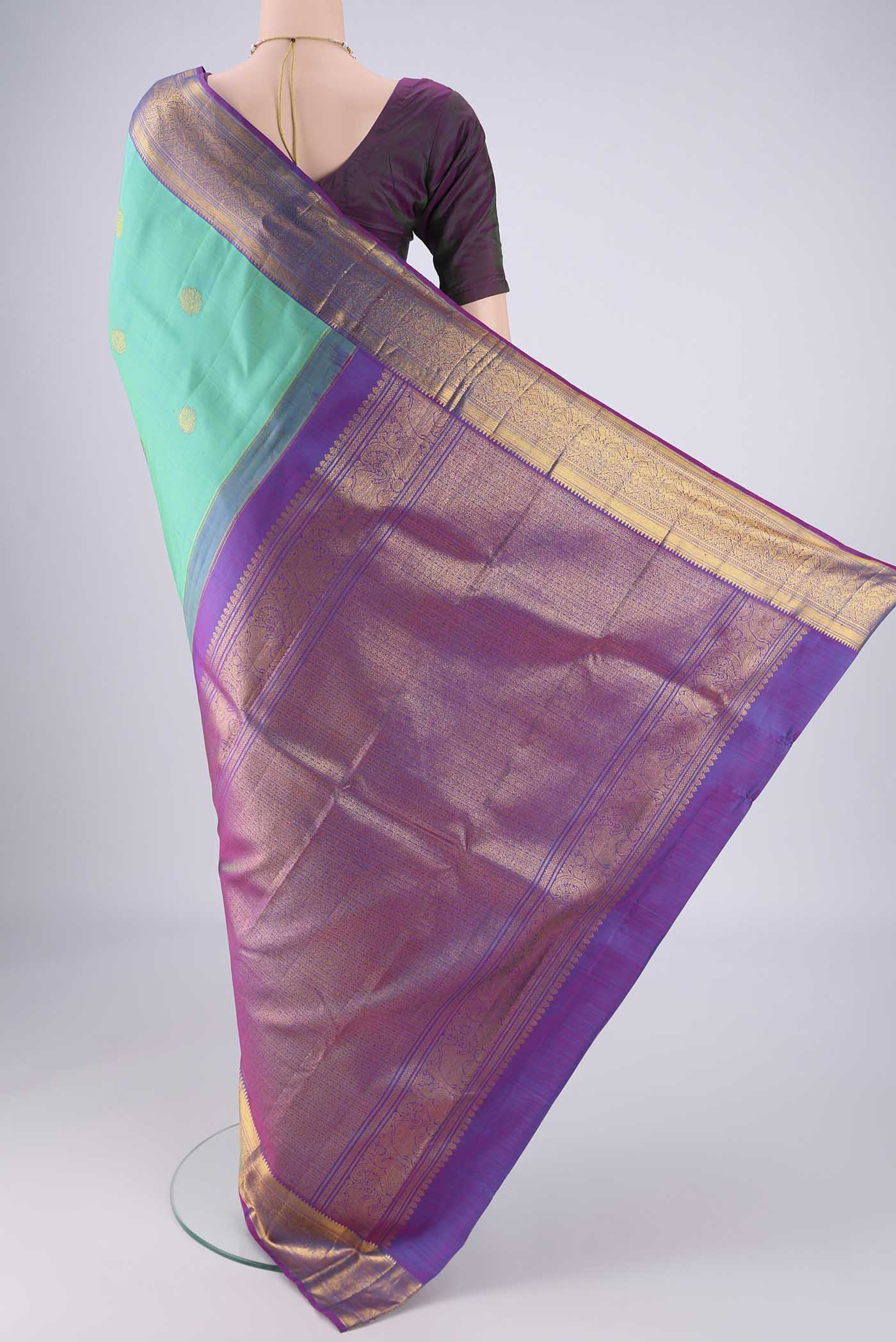 Flat view of Turquoise Kanjivaram Silk Saree with Zari Butta on the body and Zari Border. 