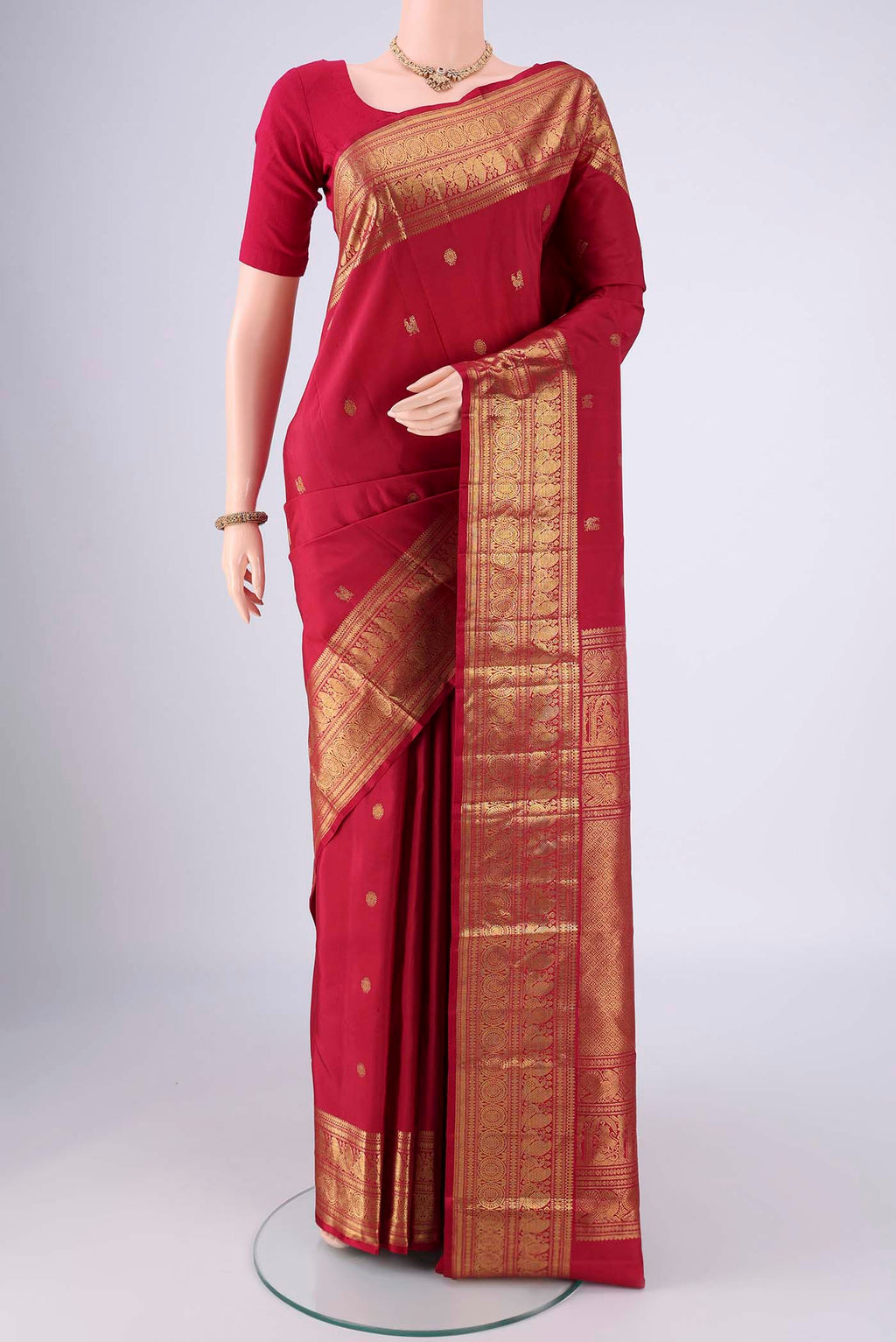 Maroon Dual Tone Kanjivaram Saree with Zari Butta on the body and Zari Border.  displayed on a mannequin