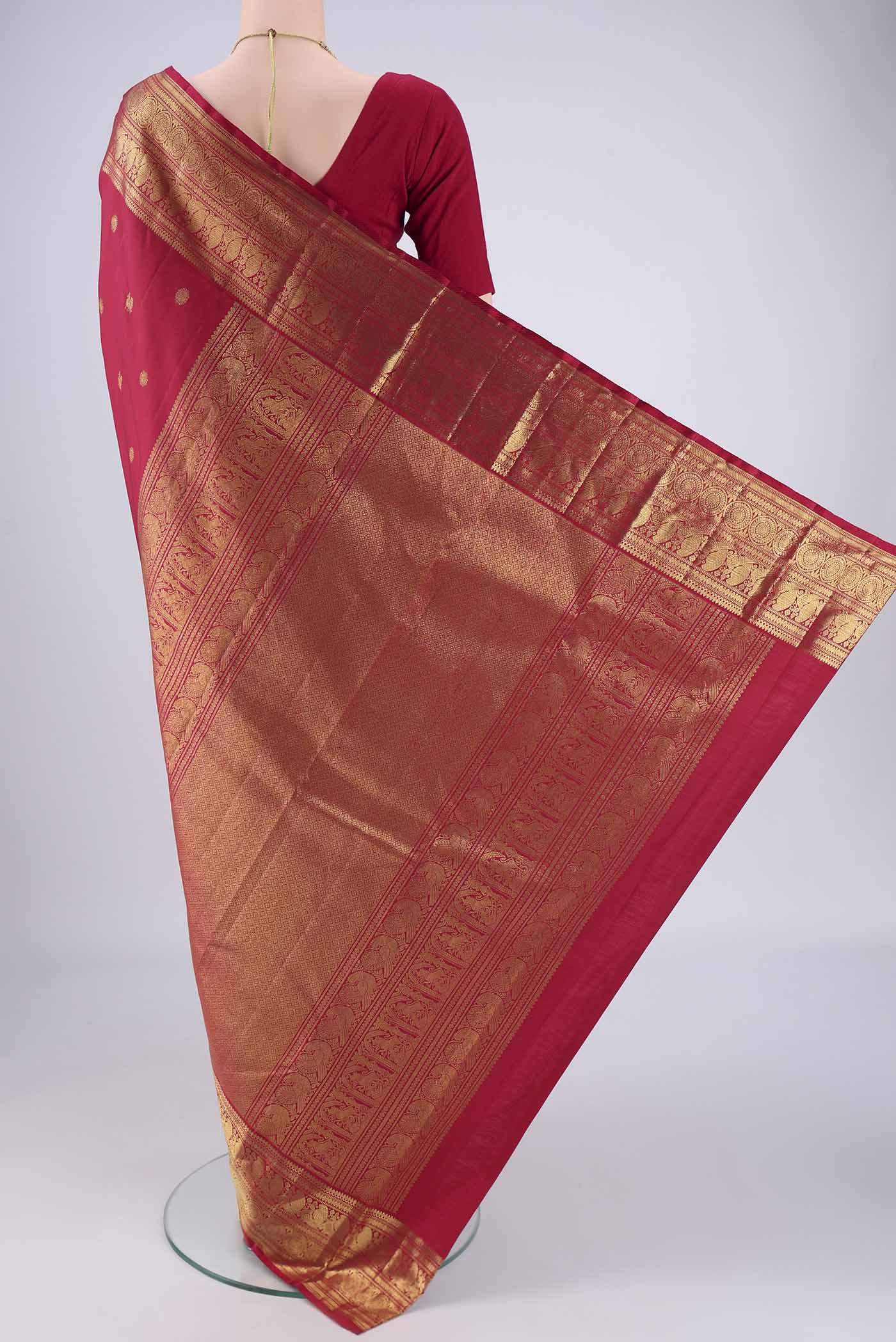 Flat view of Maroon Dual Tone Kanjivaram Saree with Zari Butta on the body and Zari Border. 