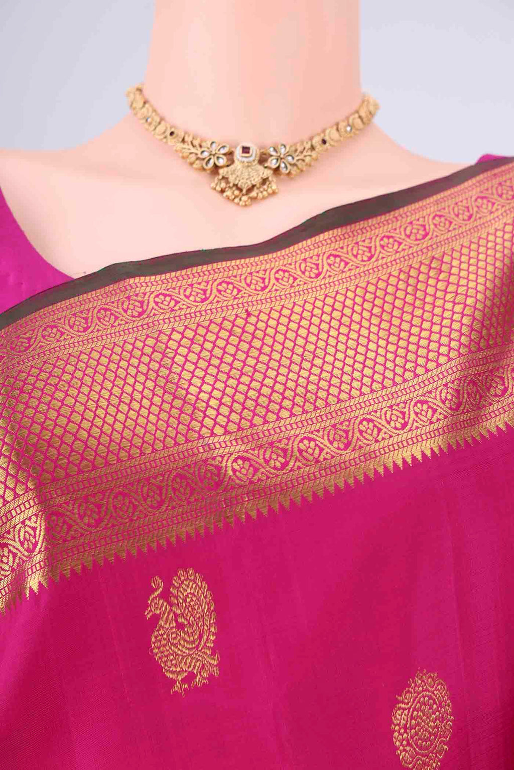 Border image of Rani Pink Dual Tone Kanjivaram Saree with Zari Butta on the body and Zari Border. 