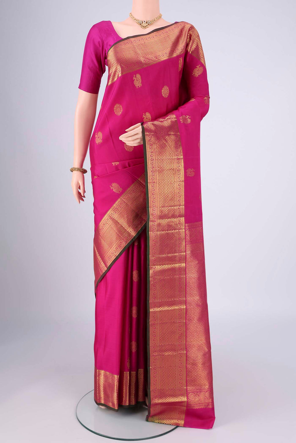 Rani Pink Dual Tone Kanjivaram Saree with Zari Butta on the body and Zari Border.  displayed on a mannequin