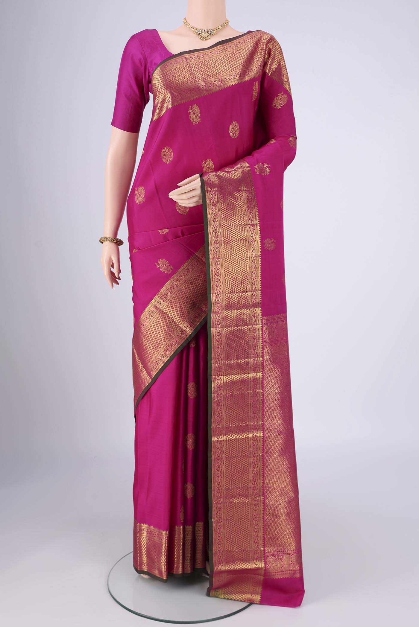 Rani Pink Dual Tone Kanjivaram Saree with Zari Butta on the body and Zari Border.  displayed on a mannequin