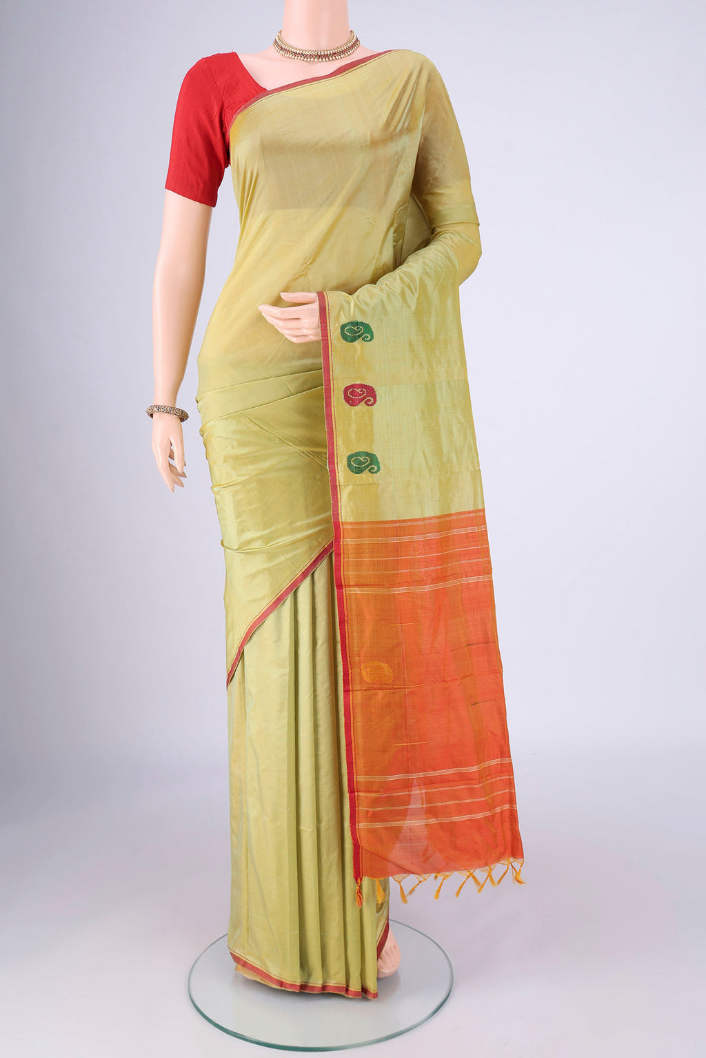 Light Green Dual Tone Kanchipuram Silk Saree with Plain Body and Thread Border.  displayed on a mannequin