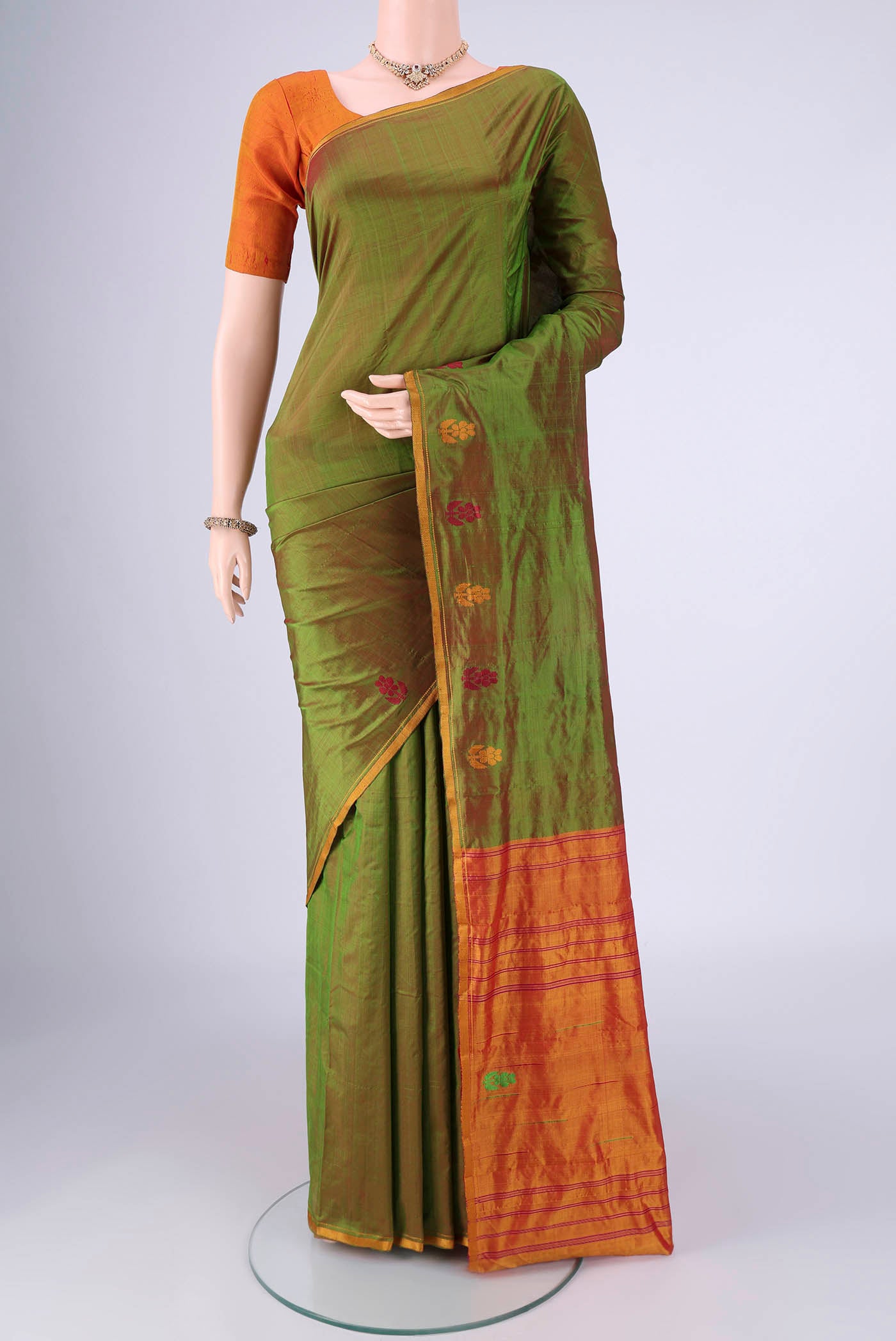 Light Green Kanchipuram Silk Saree with Plain Body and Thread Border.  displayed on a mannequin
