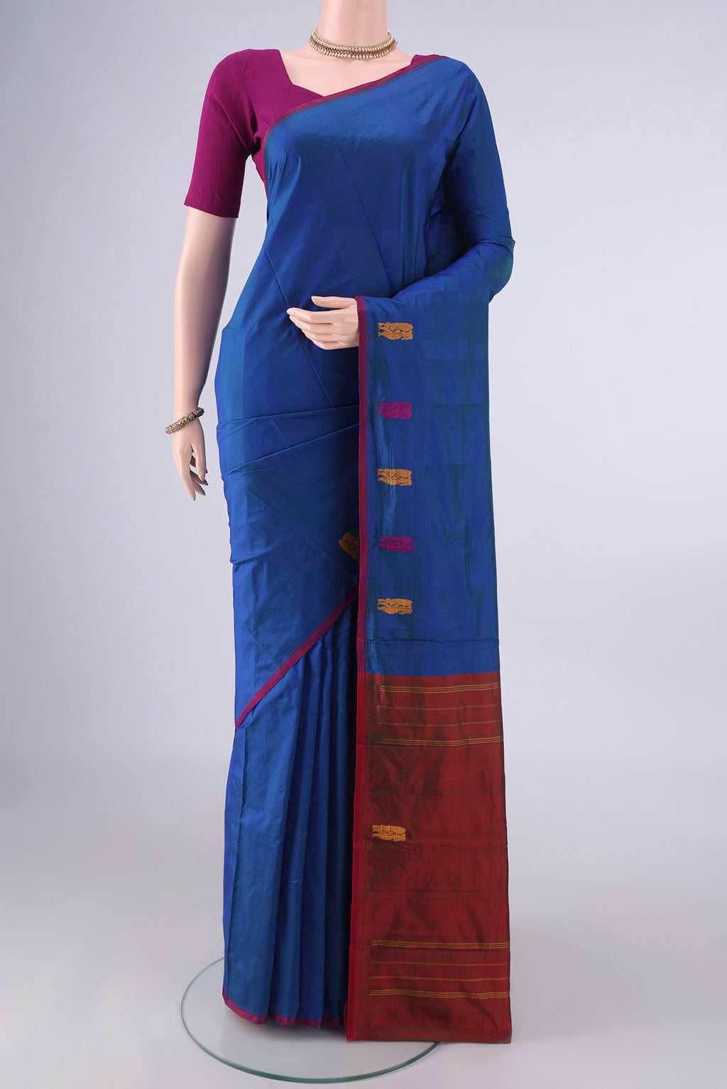 Pure Silk Blue Kanchipuram Saree with Plain Body and Thread Border.  displayed on a mannequin