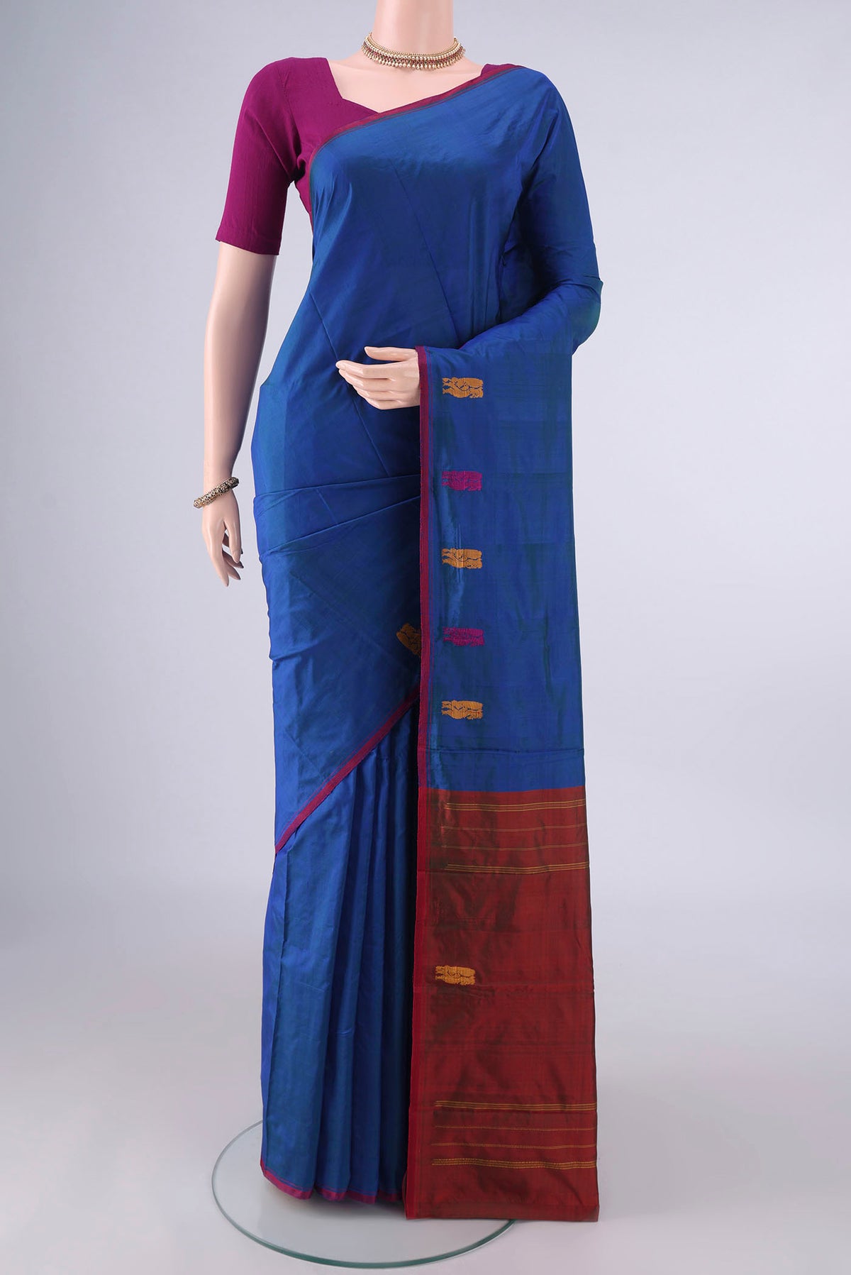 Pure Silk Blue Kanchipuram Saree with Plain Body and Thread Border.  displayed on a mannequin