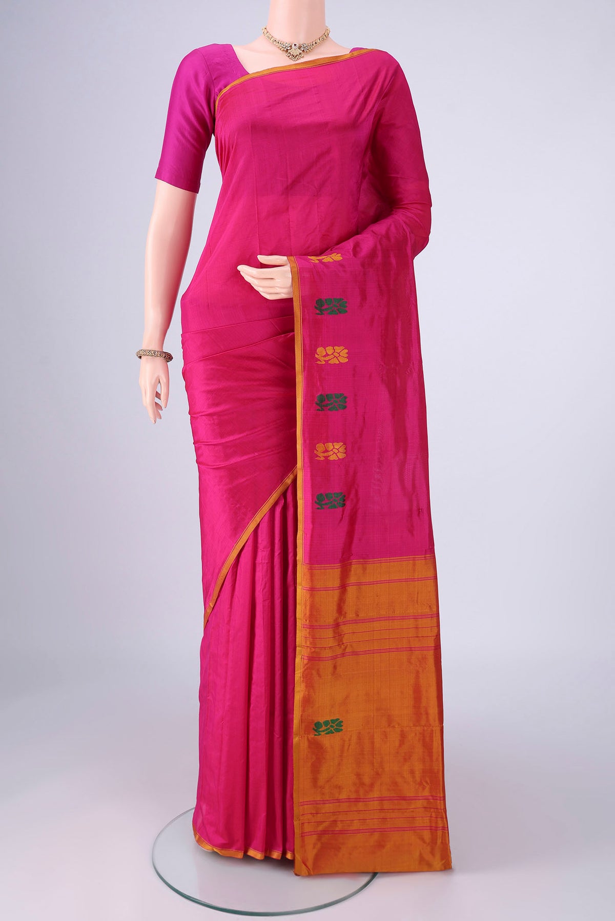 Rani Pink Kanchipuram Silk Saree with Plain Body and Thread Border.  displayed on a mannequin