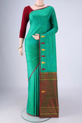 Sea Green Kanchipuram Silk Saree with Plain Body and Thread Border.  displayed on a mannequin