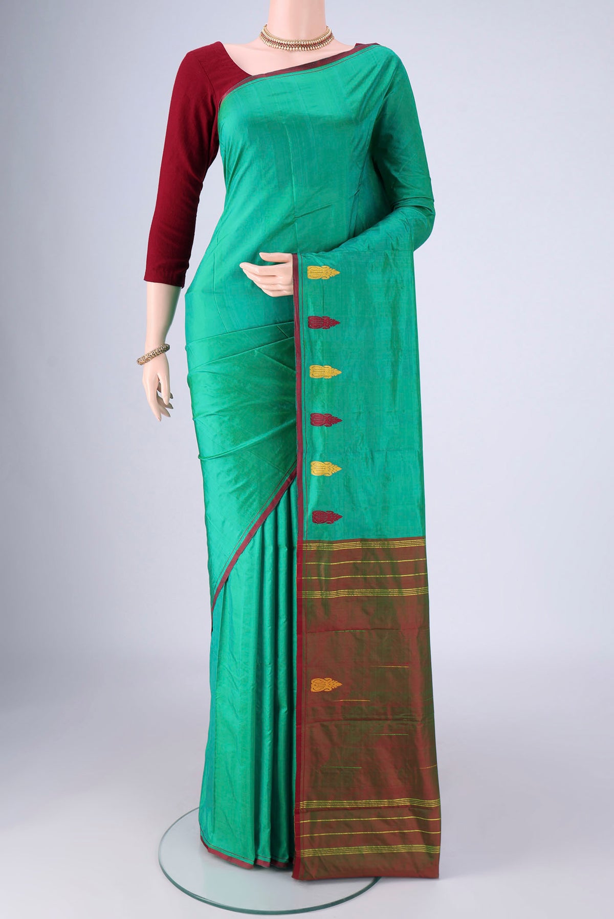 Sea Green Kanchipuram Silk Saree with Plain Body and Thread Border.  displayed on a mannequin
