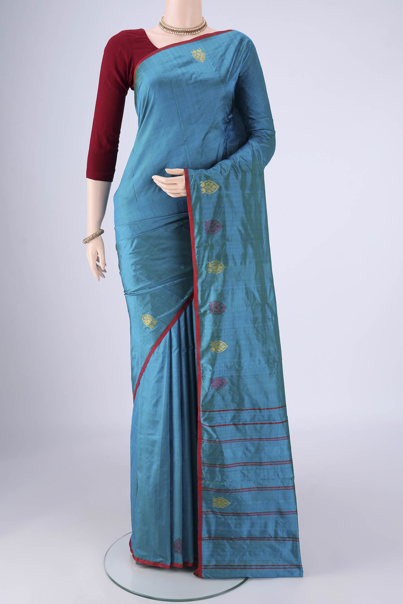 Blue Kanchipuram Silk Saree with Plain Body and Thread Border.  displayed on a mannequin