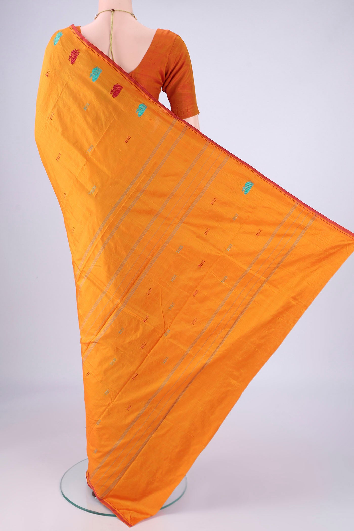 Flat view of Orange Kanchipuram Silk Saree with Plain Body and Thread Border. 