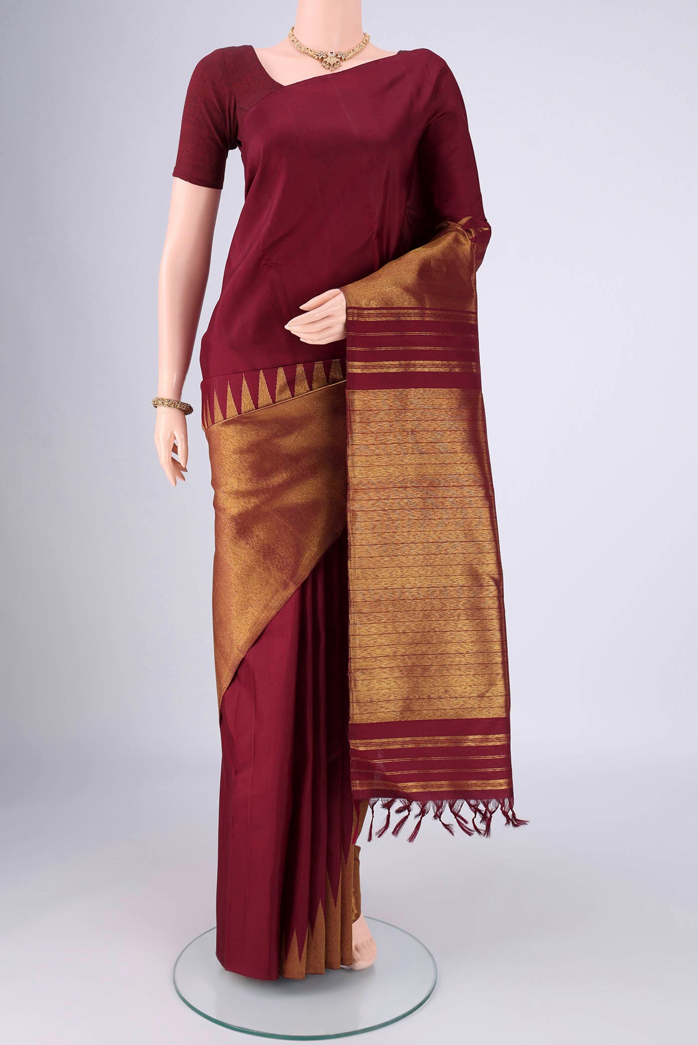 Maroon Dual Tone Kanjivaram Silk Saree with Plain Body and Rising Temple Border.  displayed on a mannequin