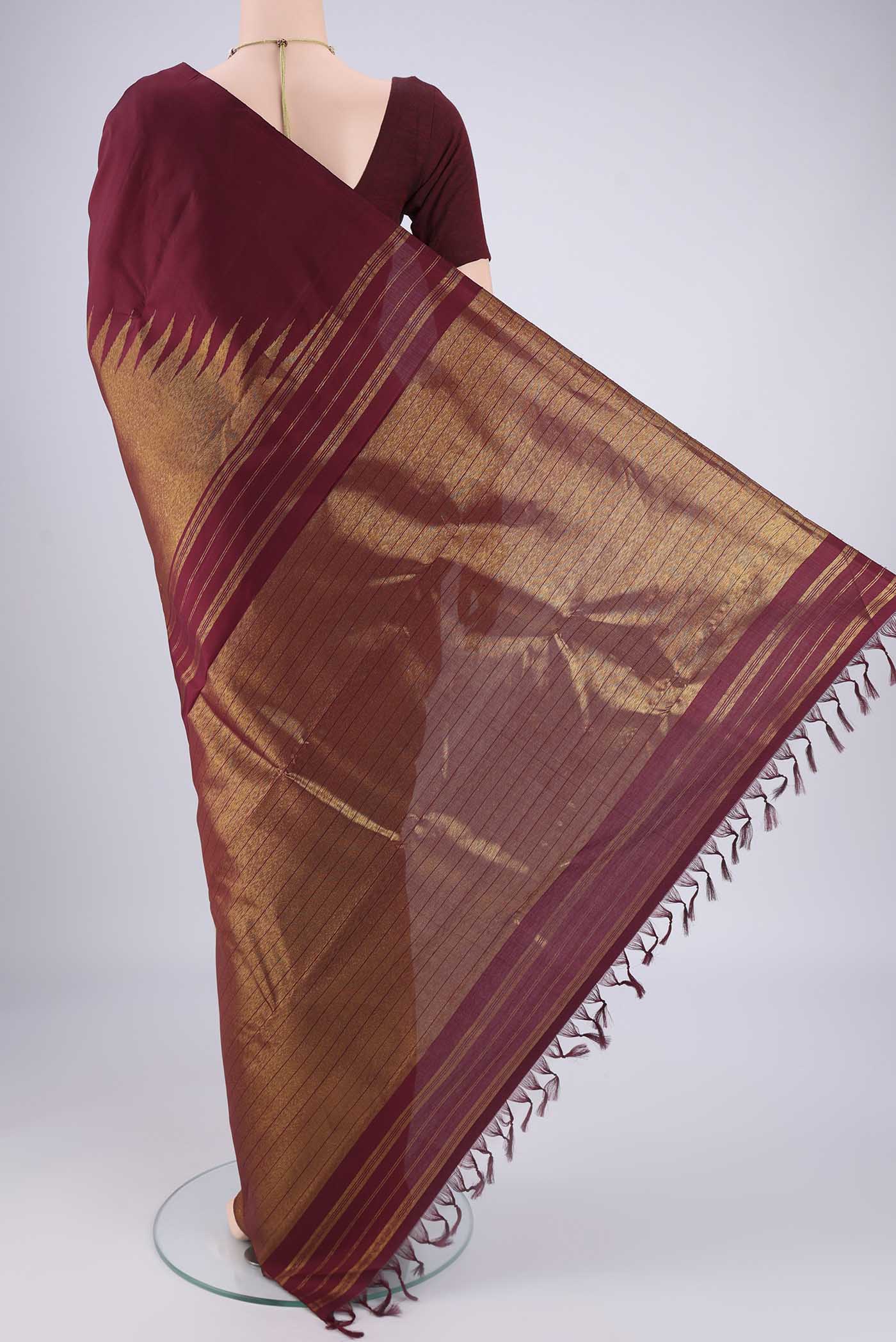 Flat view of Maroon Dual Tone Kanjivaram Silk Saree with Plain Body and Rising Temple Border. 