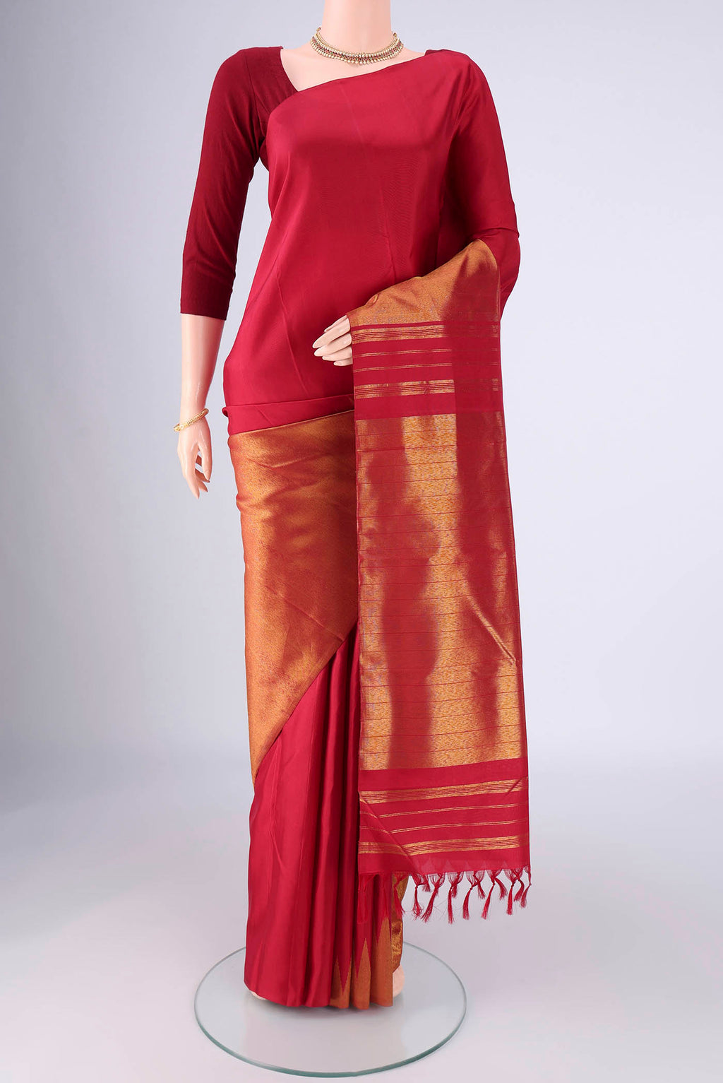 Maroon Kanjivaram Silk Saree with Plain Body and Rising Temple Border.  displayed on a mannequin