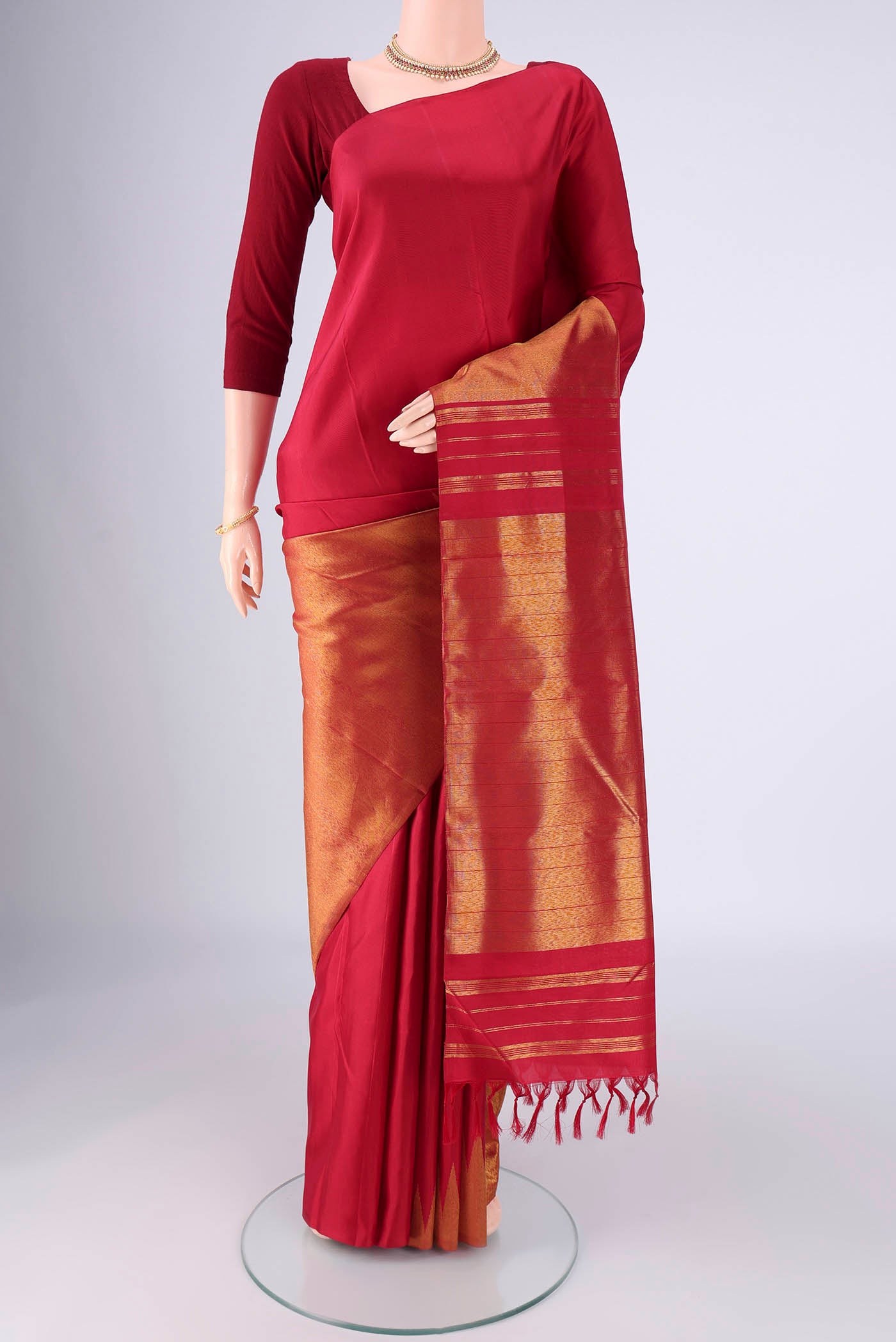 Maroon Kanjivaram Silk Saree with Plain Body and Rising Temple Border.  displayed on a mannequin