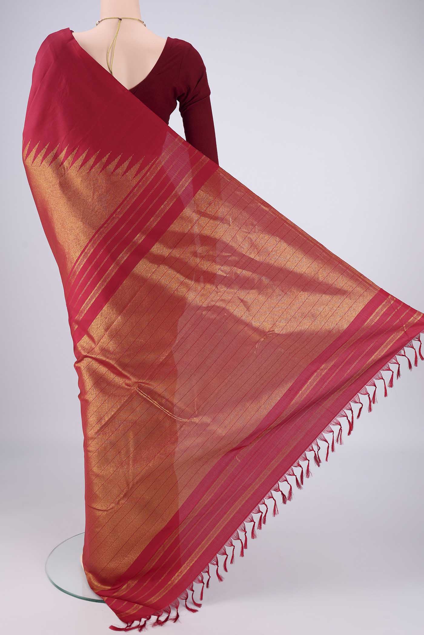 Flat view of Maroon Kanjivaram Silk Saree with Plain Body and Rising Temple Border. 