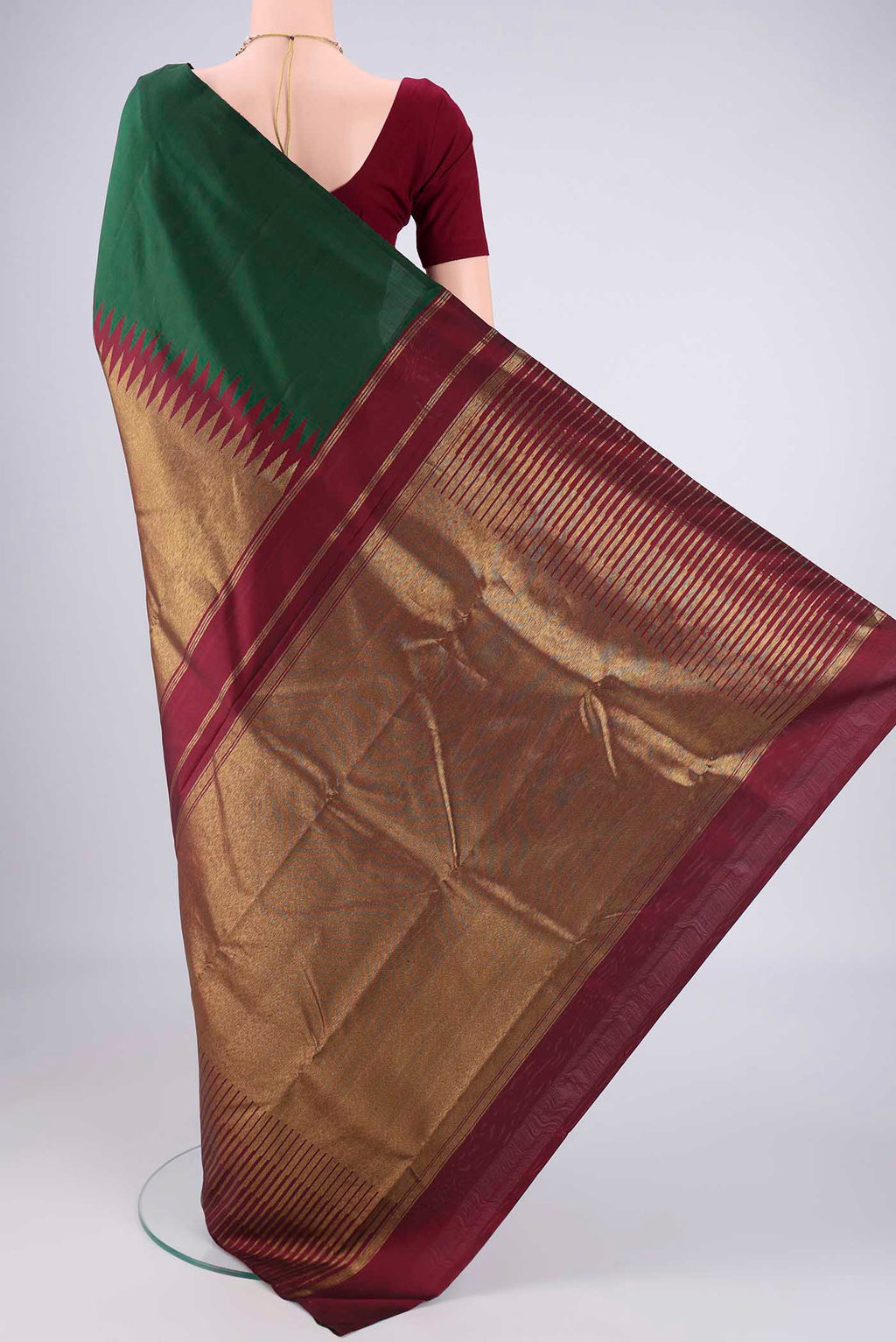 Flat view of Bottle Green Kanjivaram Silk Saree with Plain Body and Rising Temple Border. 