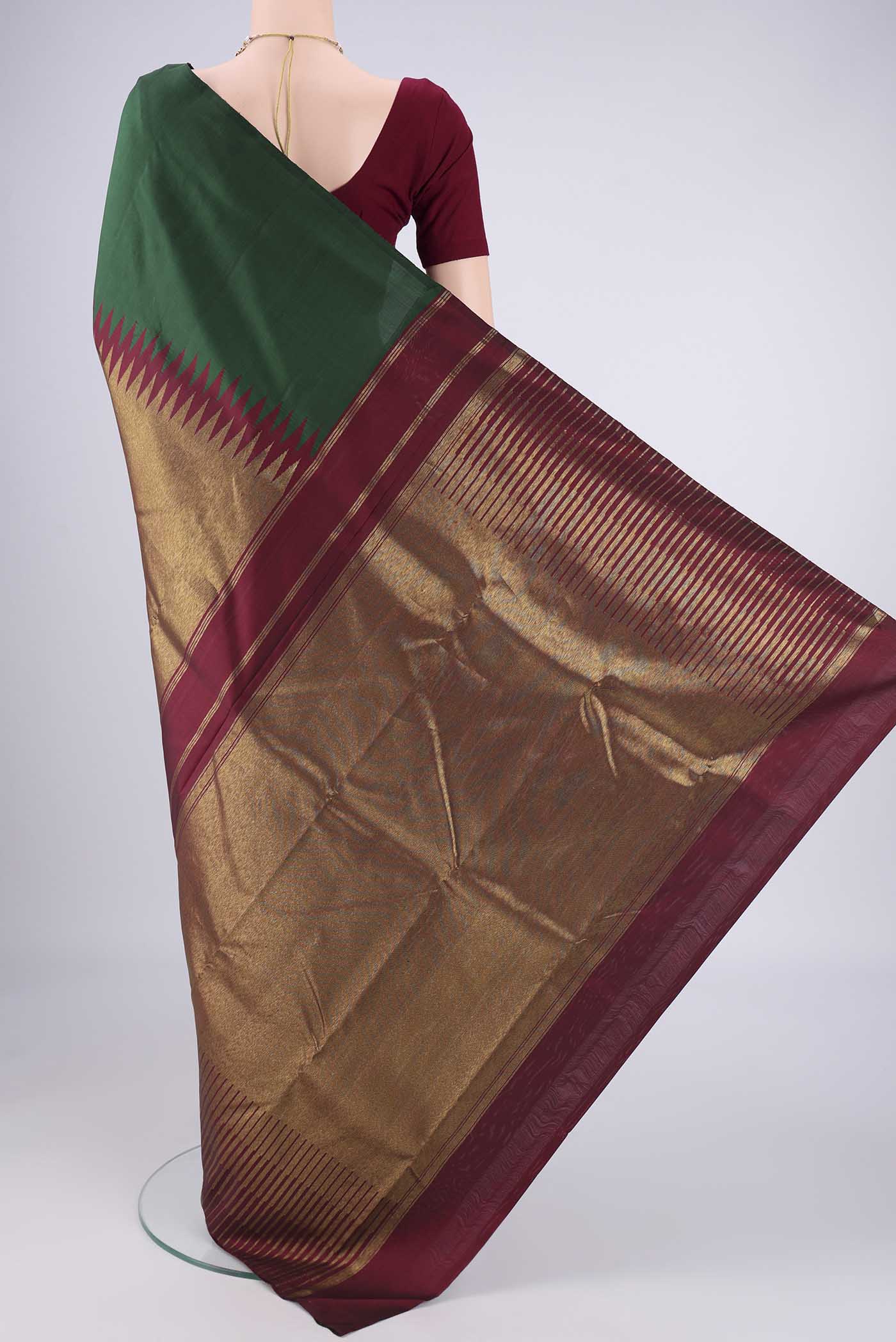 Flat view of Bottle Green Kanjivaram Silk Saree with Plain Body and Rising Temple Border. 