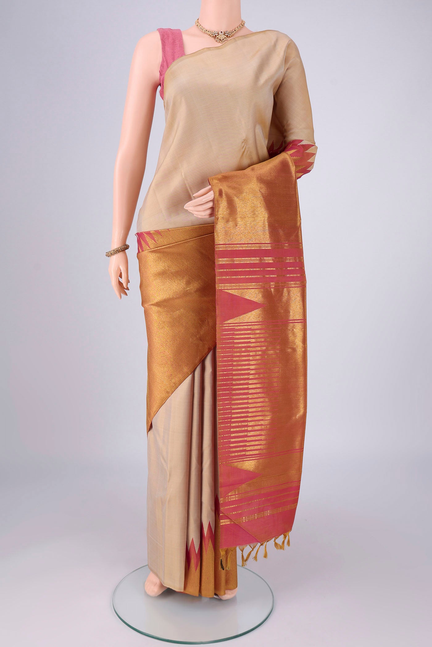 Beige Dual Tone Kanjivaram Silk Saree with Plain Body and Rising Temple Border.  displayed on a mannequin