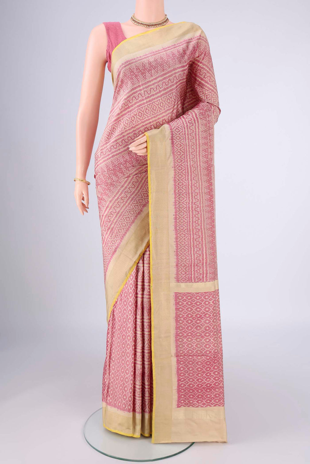 Rose Gold Pochampally Silk Saree with Pure Ikat on the body and Zari Border.  displayed on a mannequin