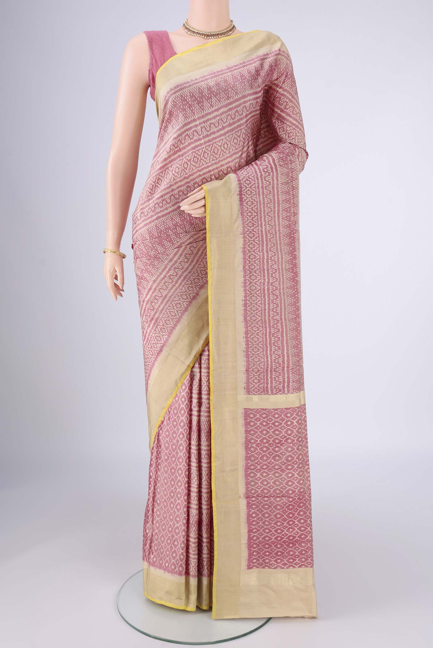 Rose Gold Pochampally Silk Saree with Pure Ikat on the body and Zari Border.  displayed on a mannequin
