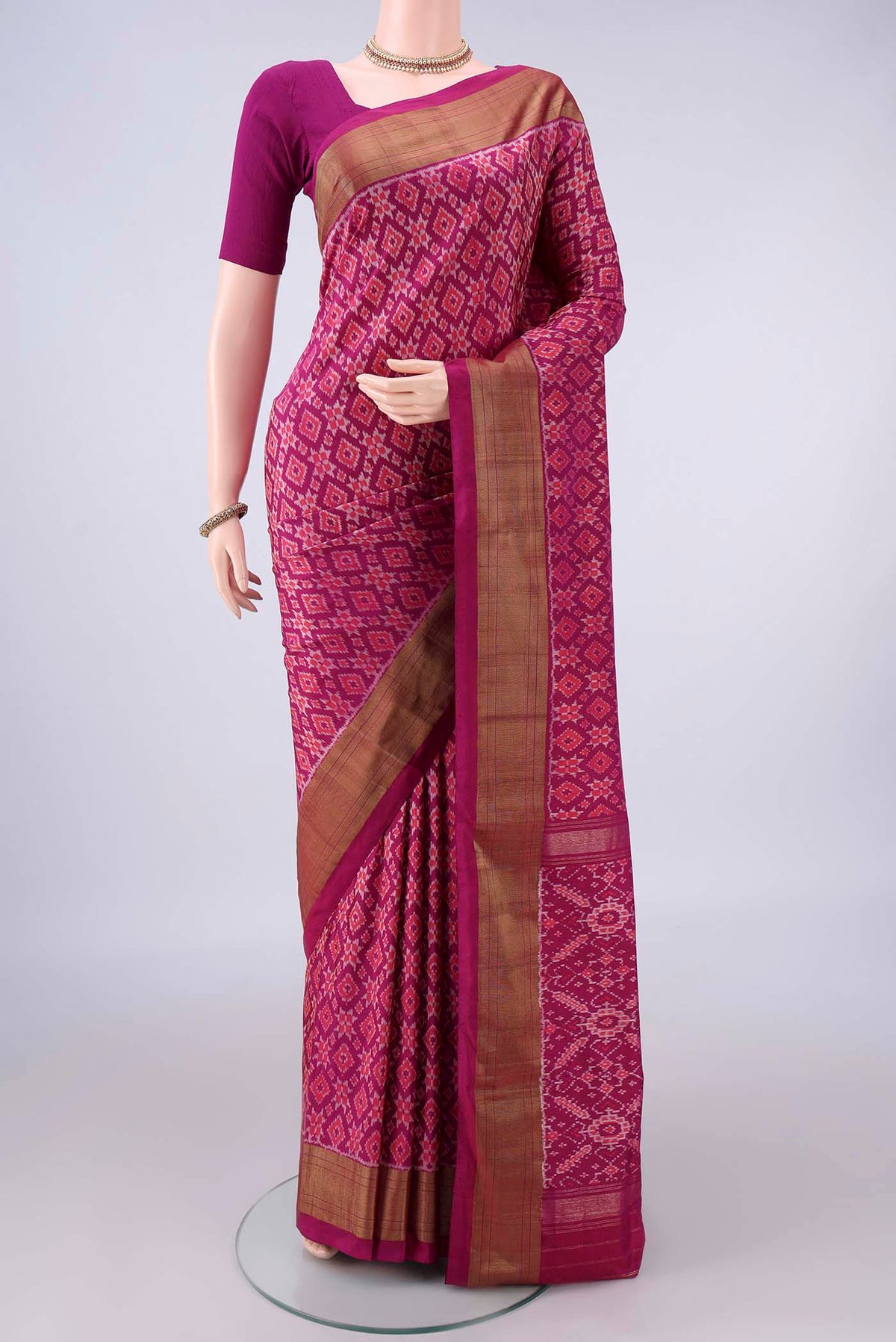 Pure Silk Magenta Pochampally Saree with Pure Ikat on the body and Zari Border.  displayed on a mannequin