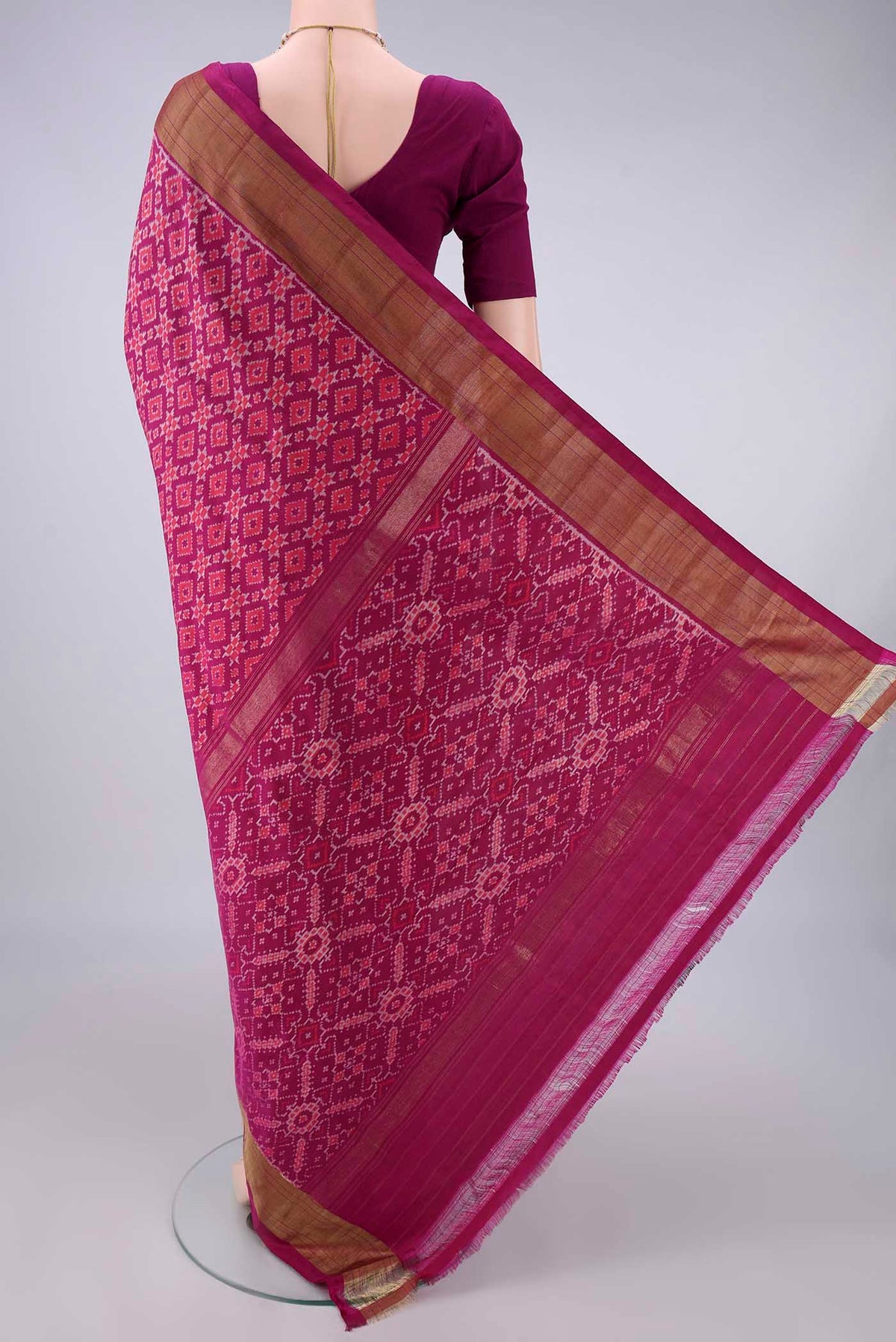 Flat view of Pure Silk Magenta Pochampally Saree with Pure Ikat on the body and Zari Border. 