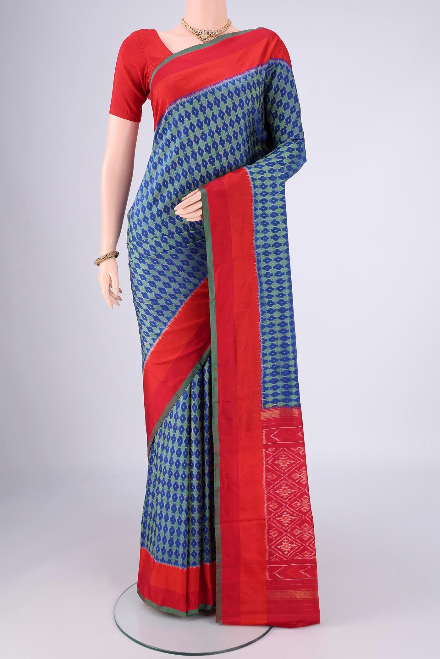 Blue Pochampally Silk Saree with Ikat design on the body and Zari Border.  displayed on a mannequin