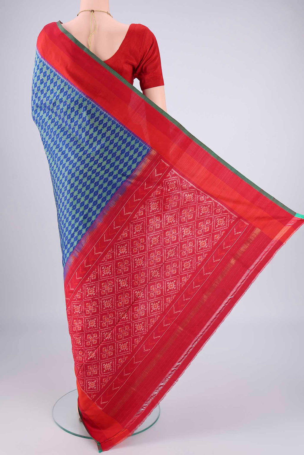 Flat view of Blue Pochampally Silk Saree with Ikat design on the body and Zari Border. 