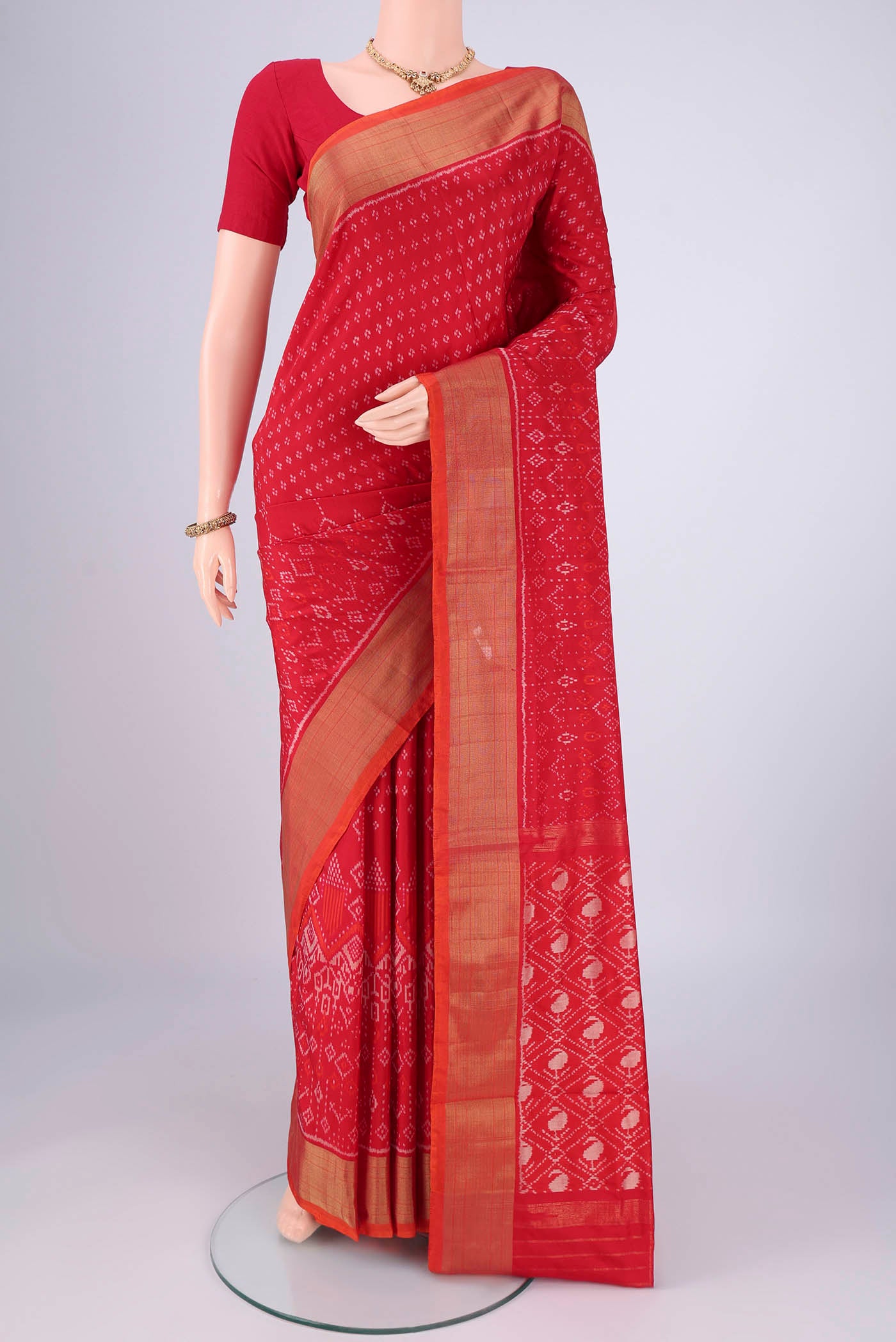 Red Pochampally Silk Saree with Ikat design on the body and Zari Border.  displayed on a mannequin